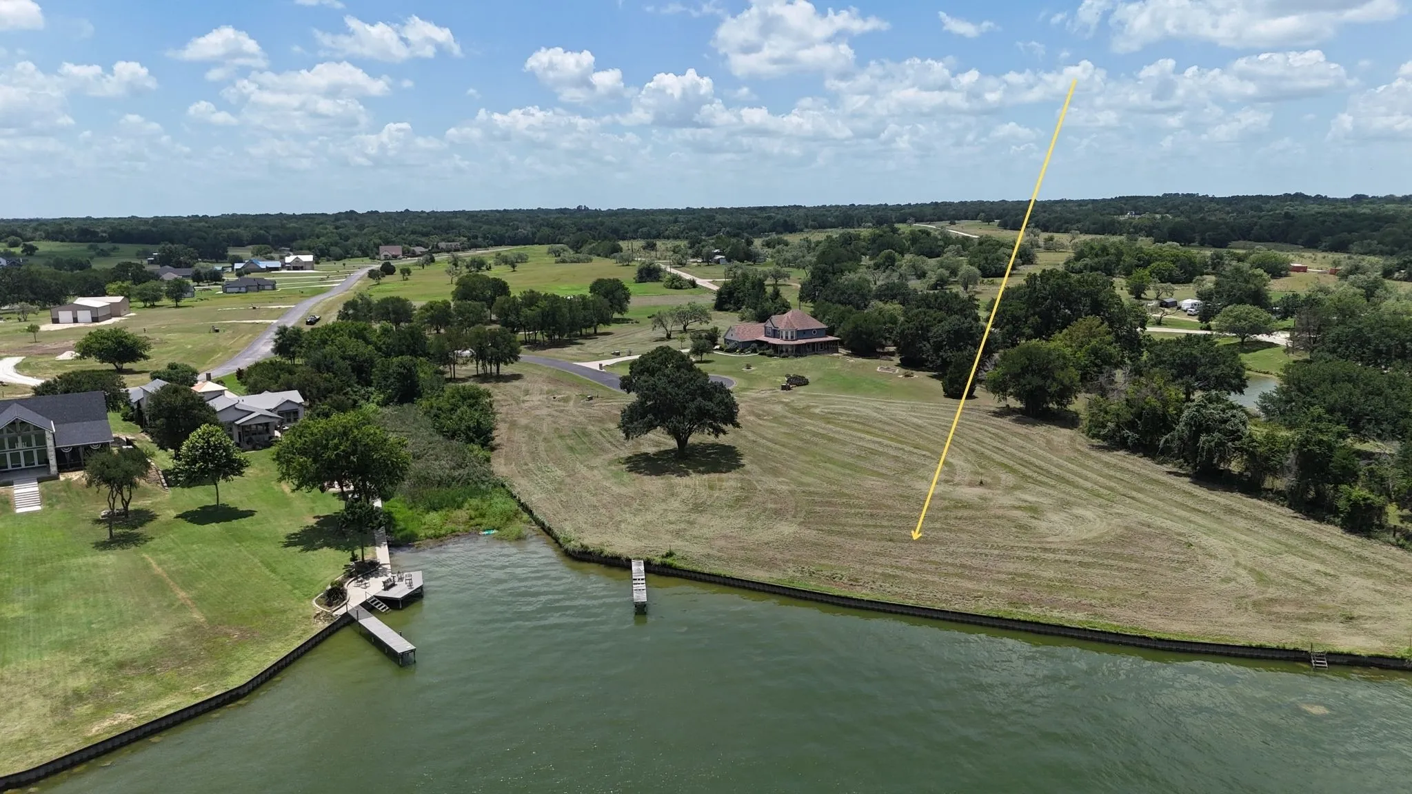 Aerial perspective highlights generous homesite dimensions and exceptional waterfront frontage.