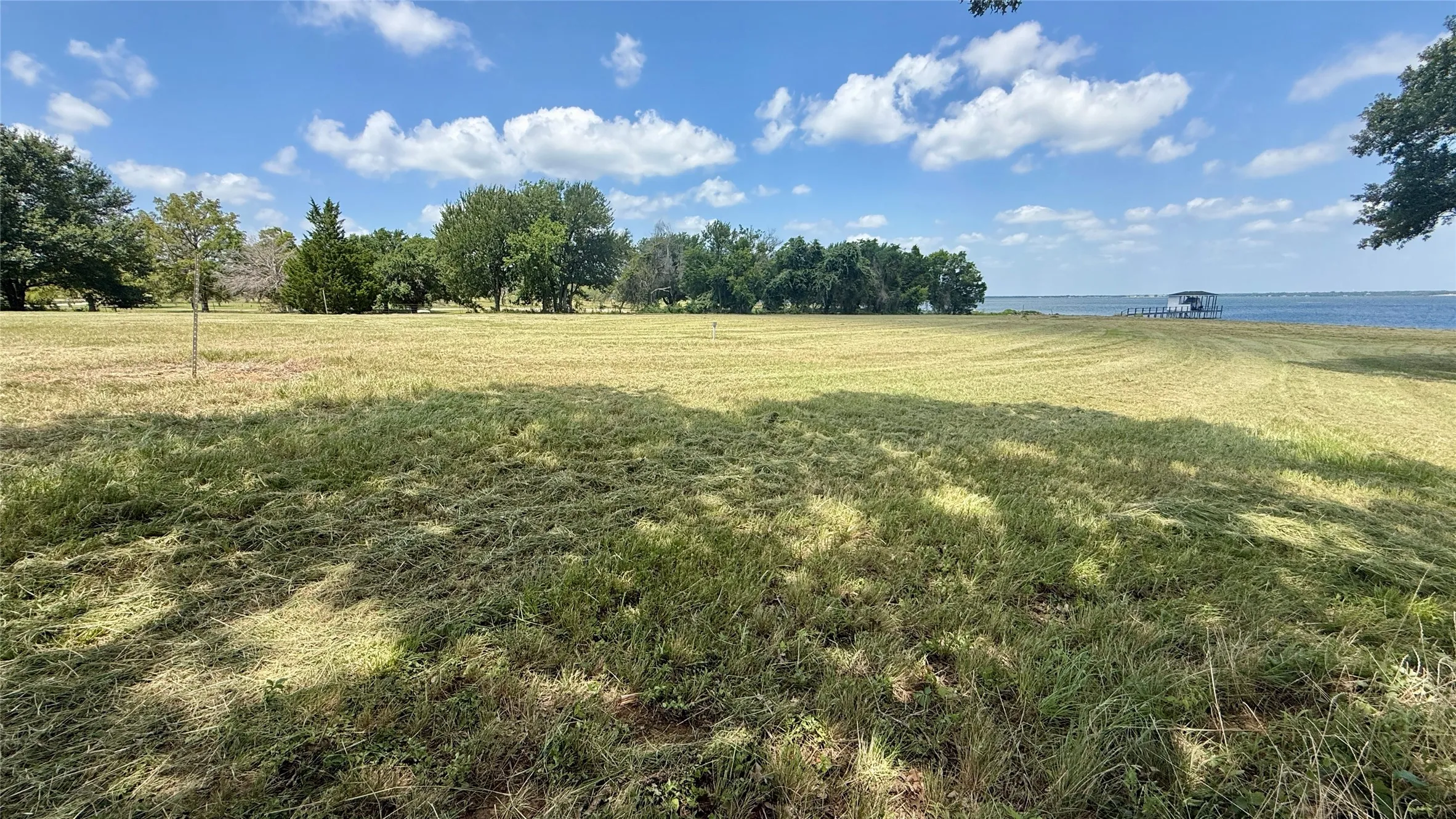 Peaceful shoreline setting offers room for entertaining and lakeside relaxation.