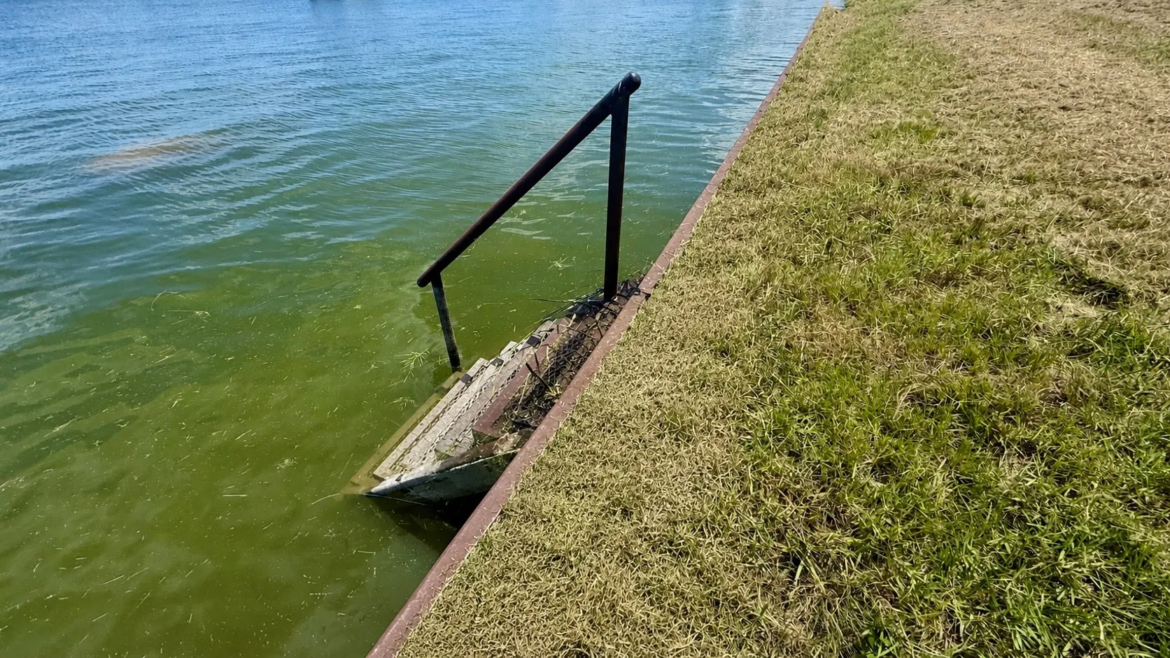 Steel retaining wall and water steps provide easy lake access for swimming, fishing, and kayaking.