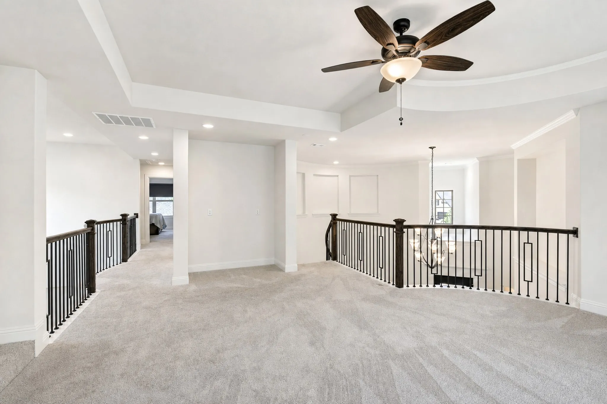Upstairs is the game room that overlooks both the entry and living room.