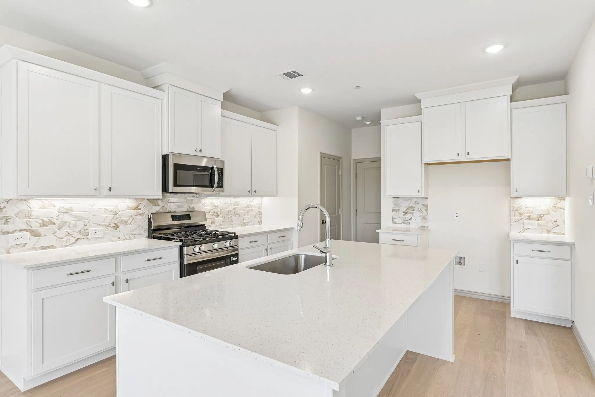 The spacious island is the hub of your new kitchen and the perfect place for friends and family to gather round!