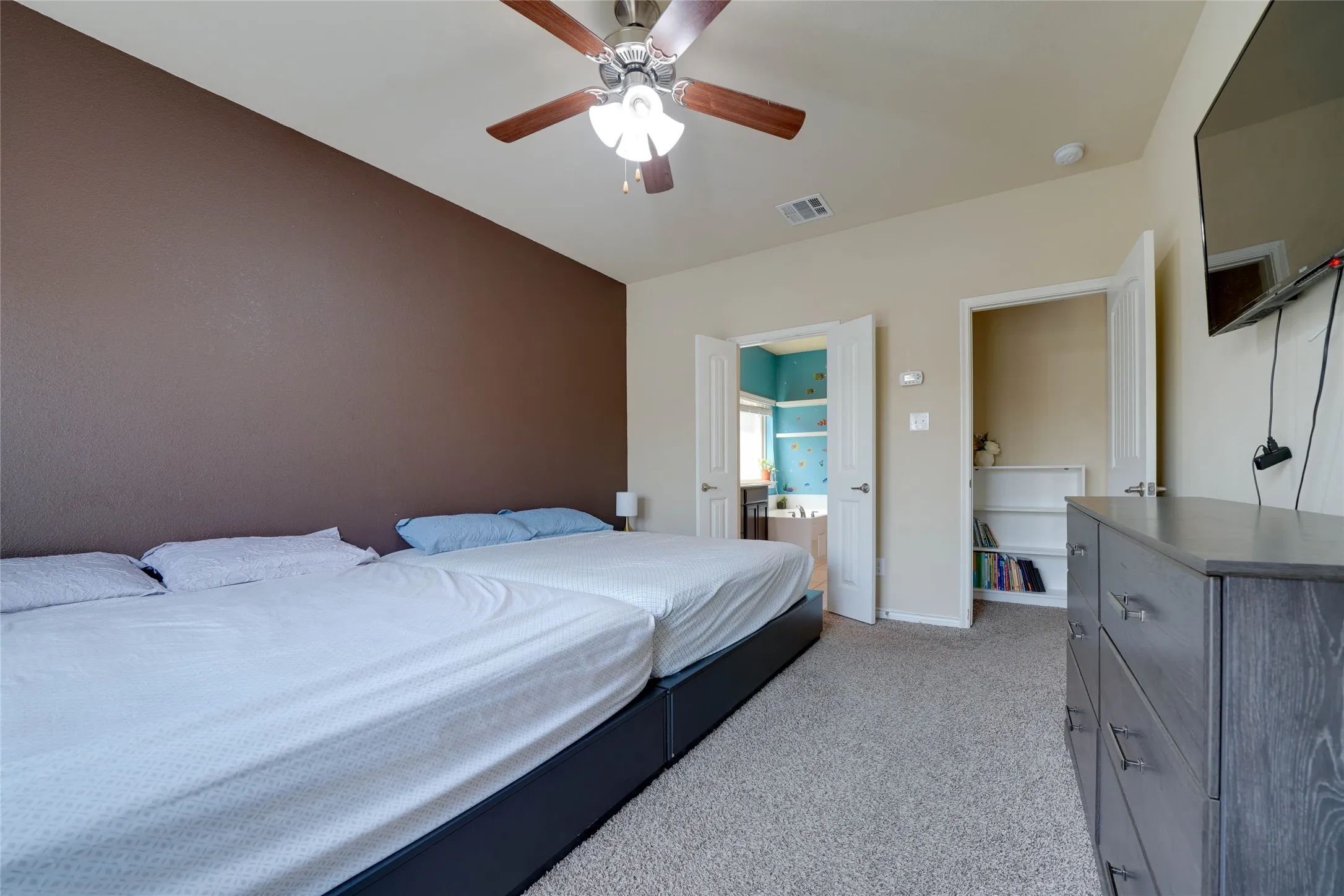 Bedroom with light carpet and ceiling fan