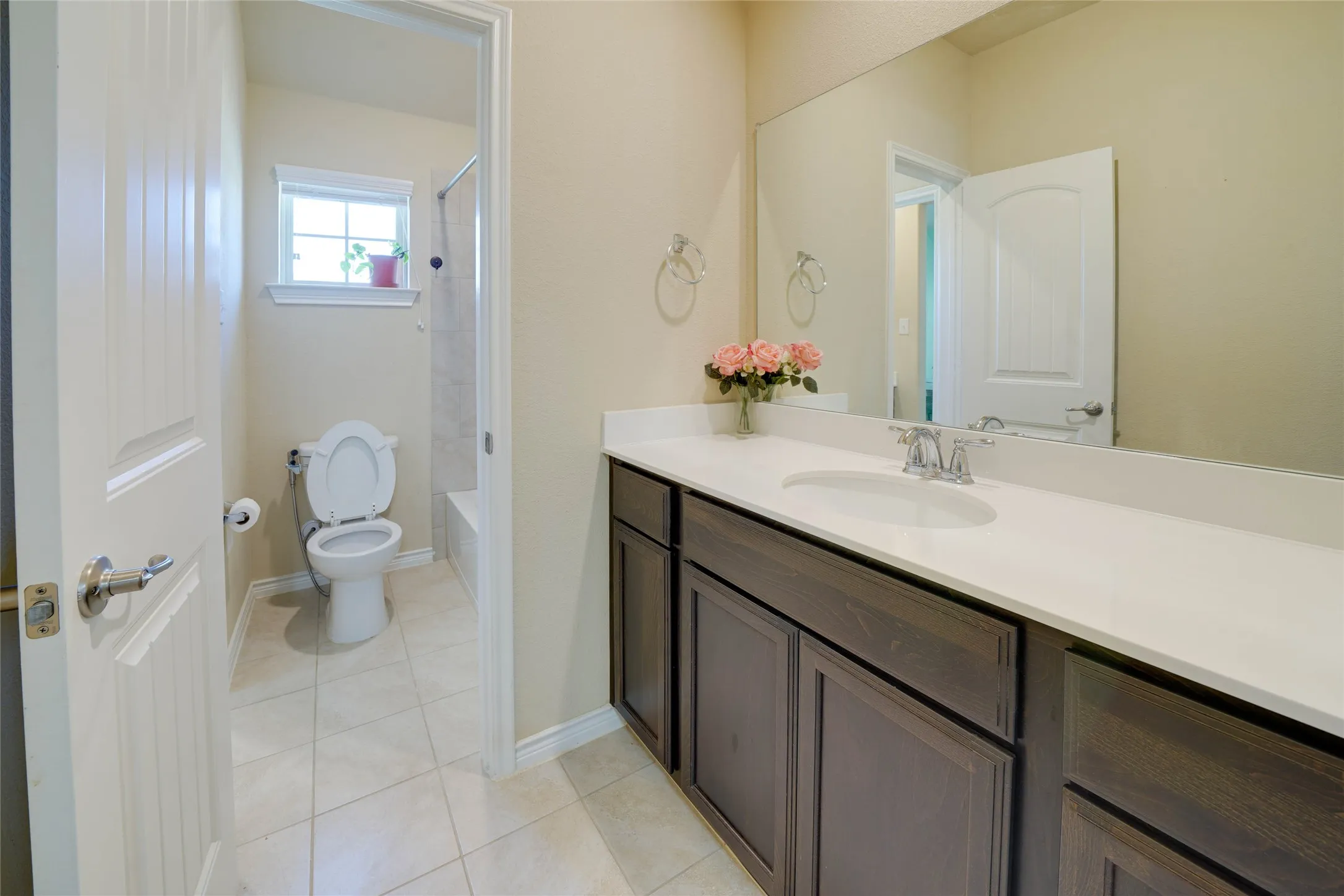 Bathroom with tile patterned floors, toilet, and vanity