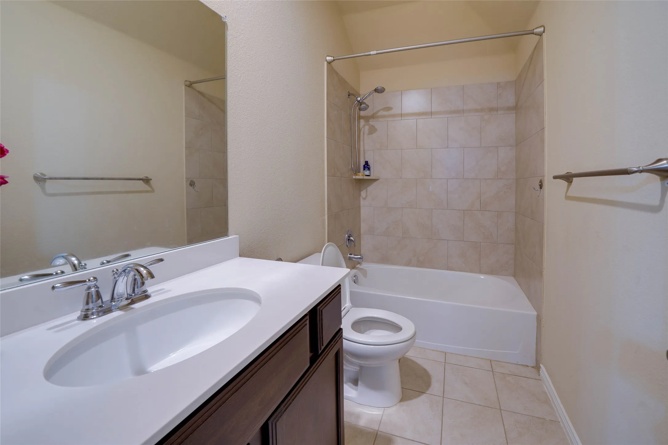 Full bathroom with vanity, tiled shower / bath, tile patterned flooring, and toilet