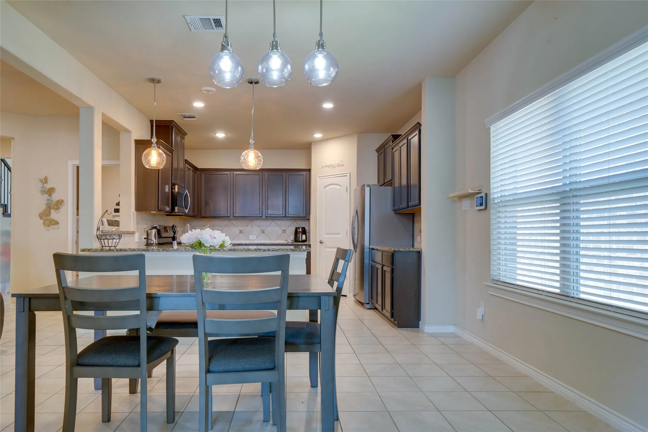 Dining area with light tile patterned flooring