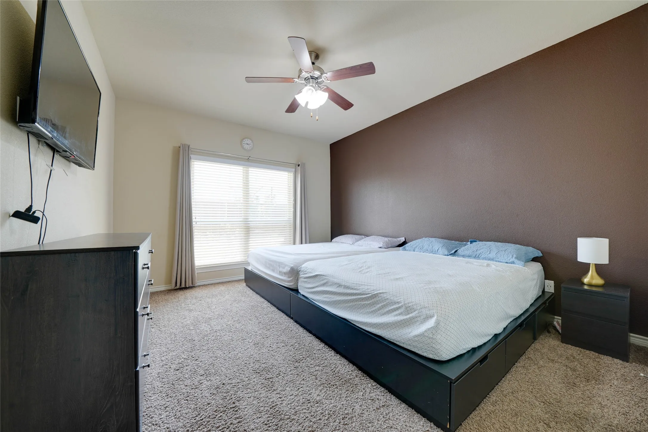 Bedroom featuring vaulted ceiling, light colored carpet, and ceiling fan