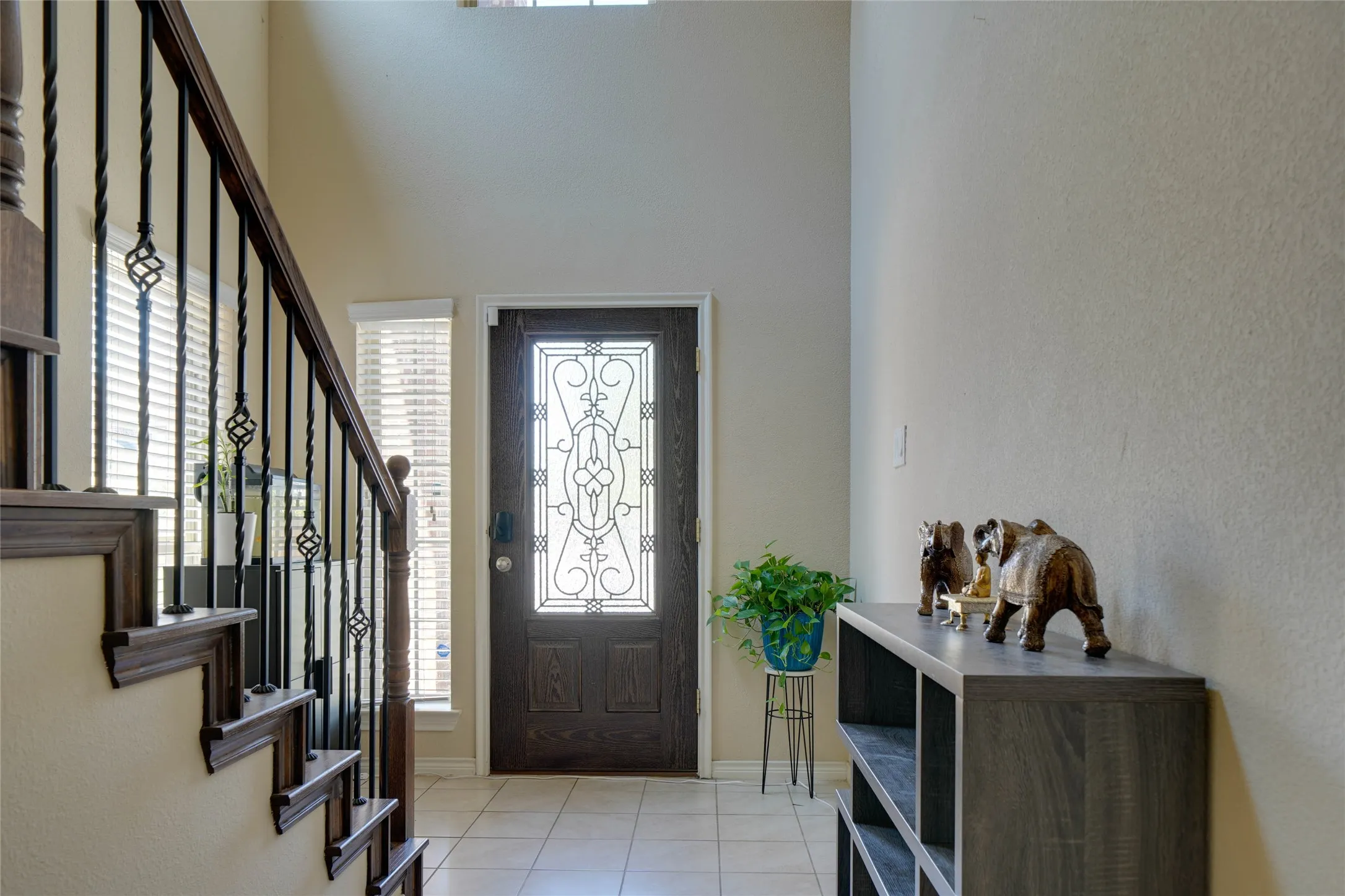 Tiled entrance foyer featuring a high ceiling and plenty of natural light