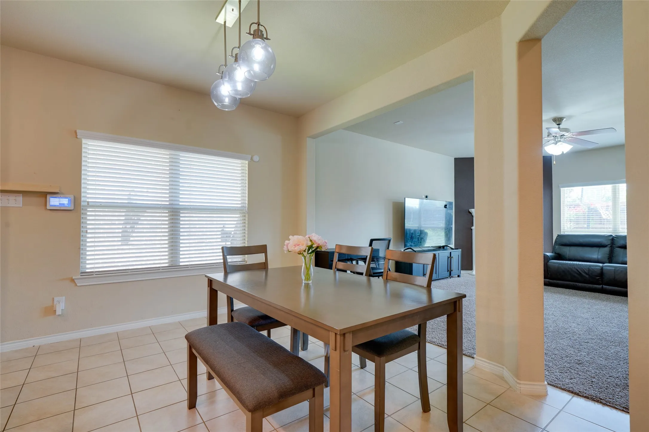 Carpeted dining area with ceiling fan
