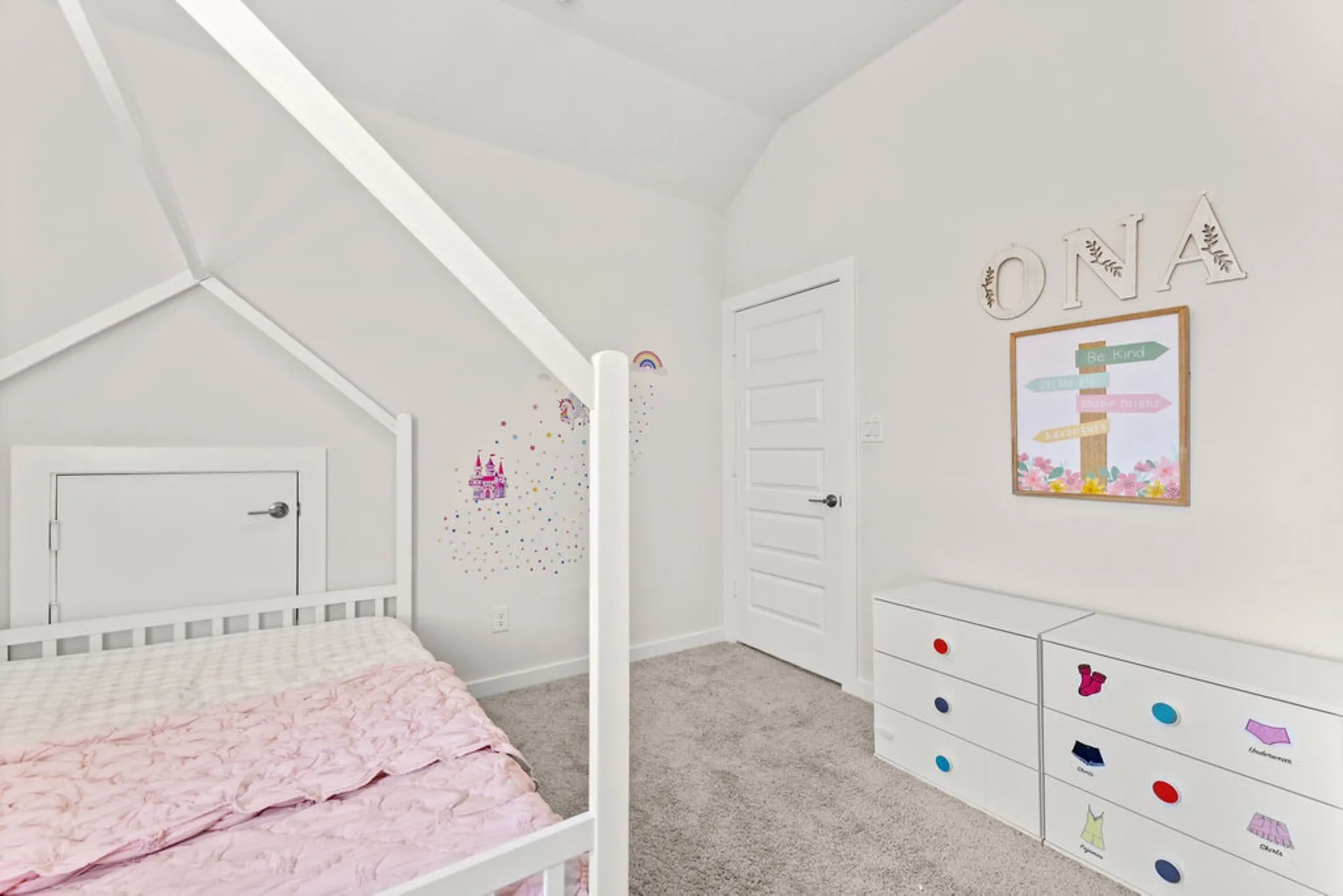 Recessed space featuring a white door, light-colored walls, and gray carpeting