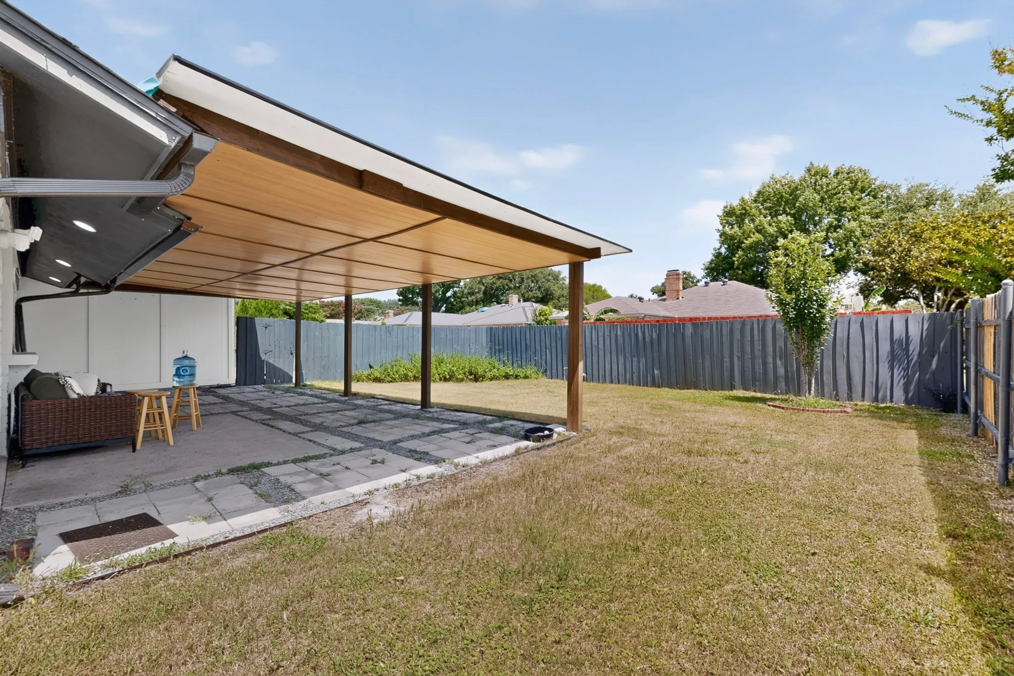 Expansive covered patio featuring a wood-look ceiling and recessed lighting