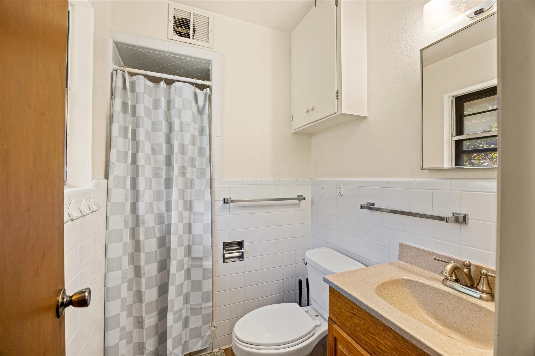 Primary Full bathroom featuring a shower with a tiled surround, a toilet, and a vanity with a drop-in sink and single-hole faucet