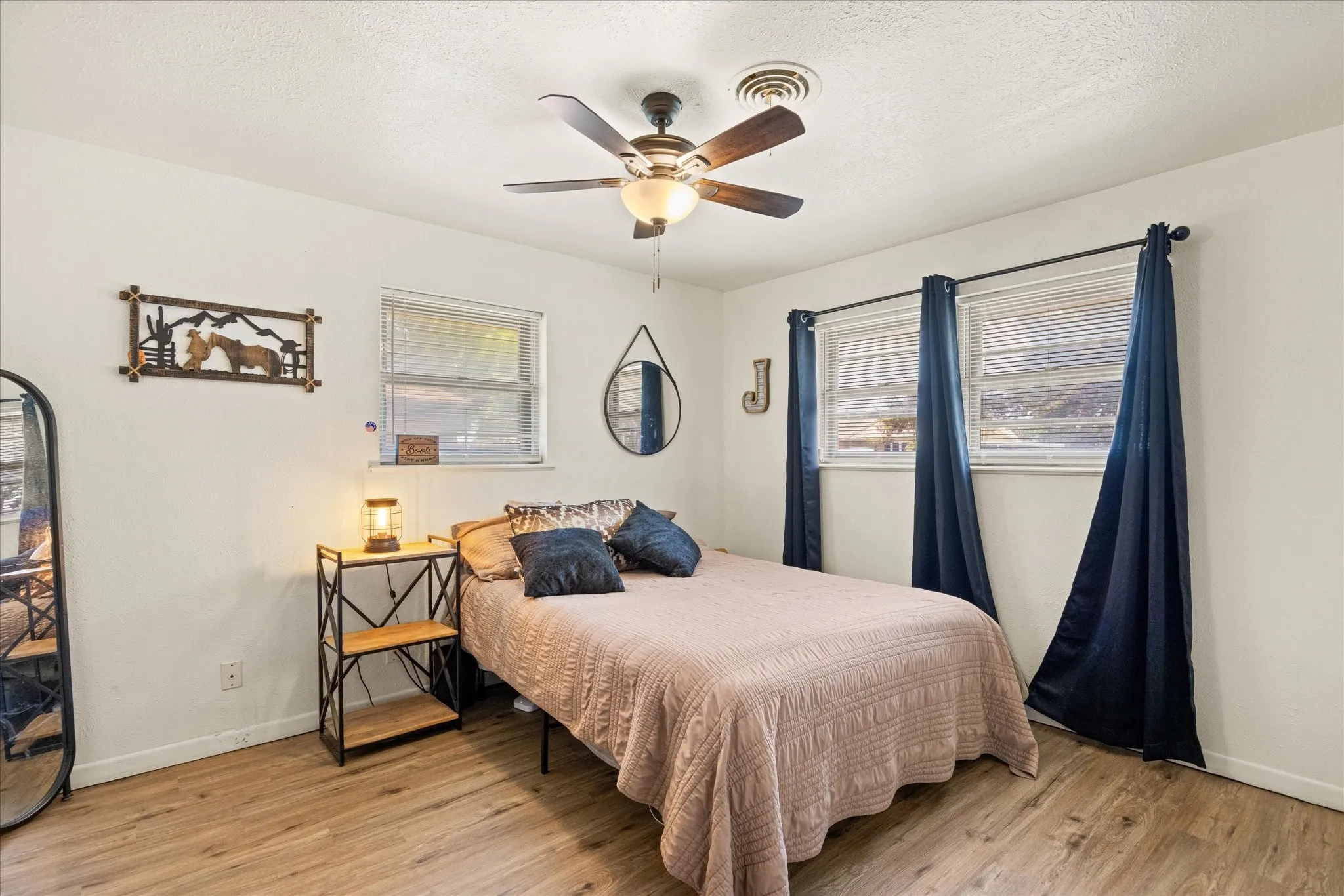 spacious bedroom with wood flooring