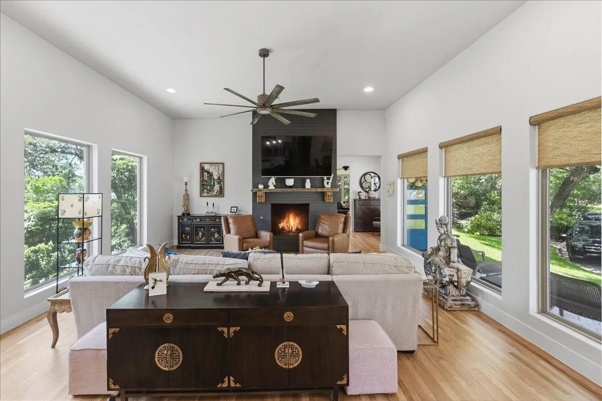 Vaulted ceilings with recessed lighting and a ceiling fan