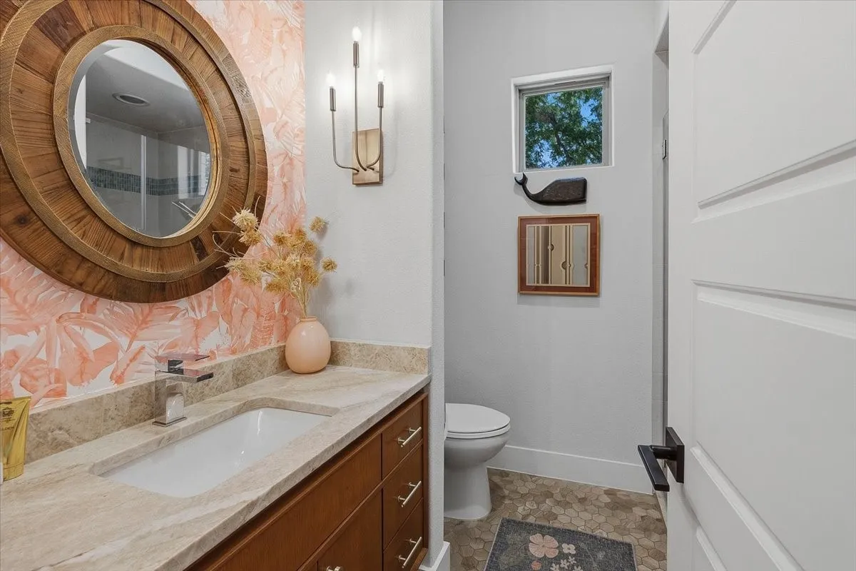 Guest Bathroom vanity featuring a stone countertop, an integrated rectangular sink, and a chrome single-handle faucet