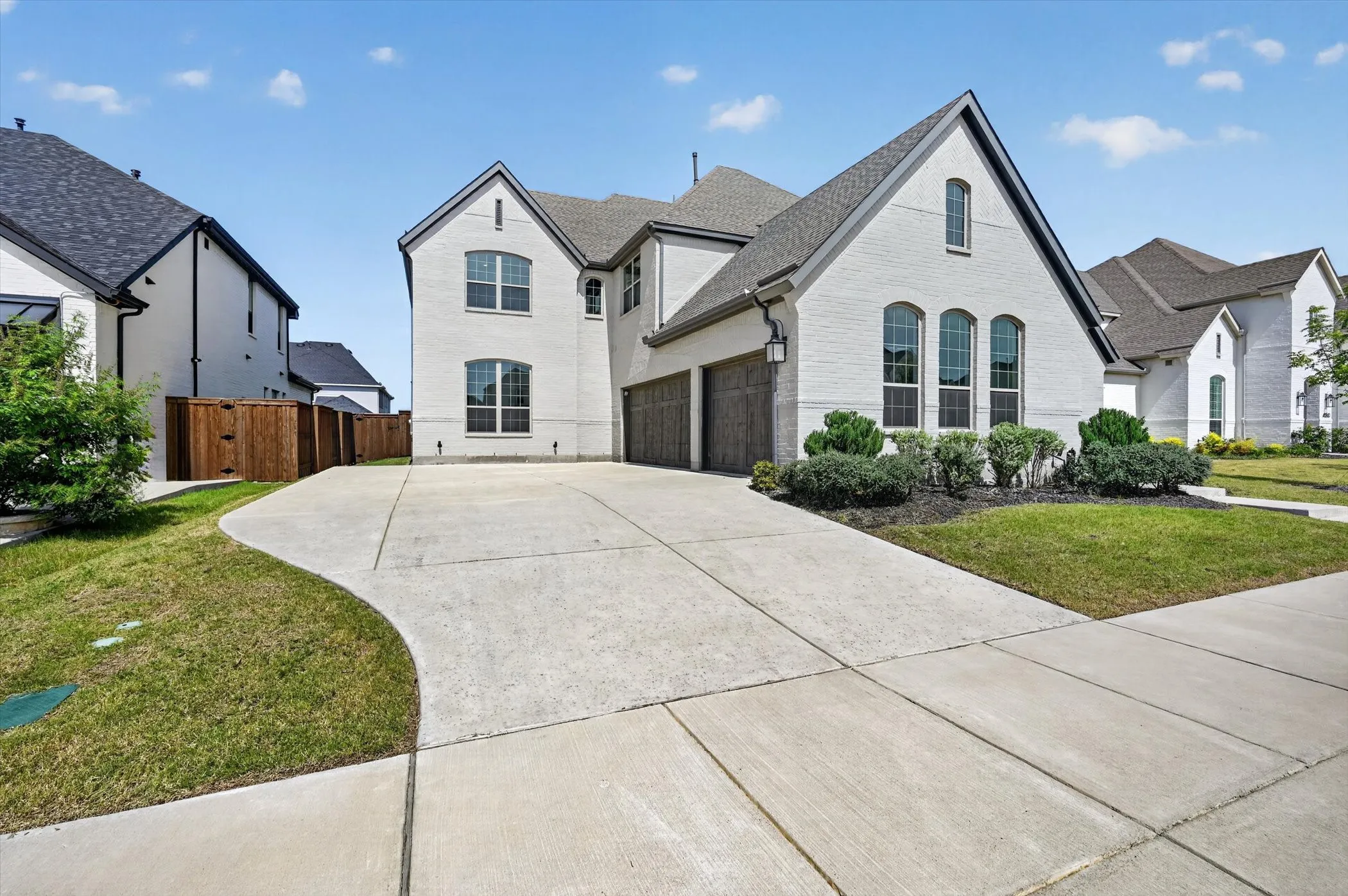 Contemporary white brick exterior with dark trim and a gabled roofline