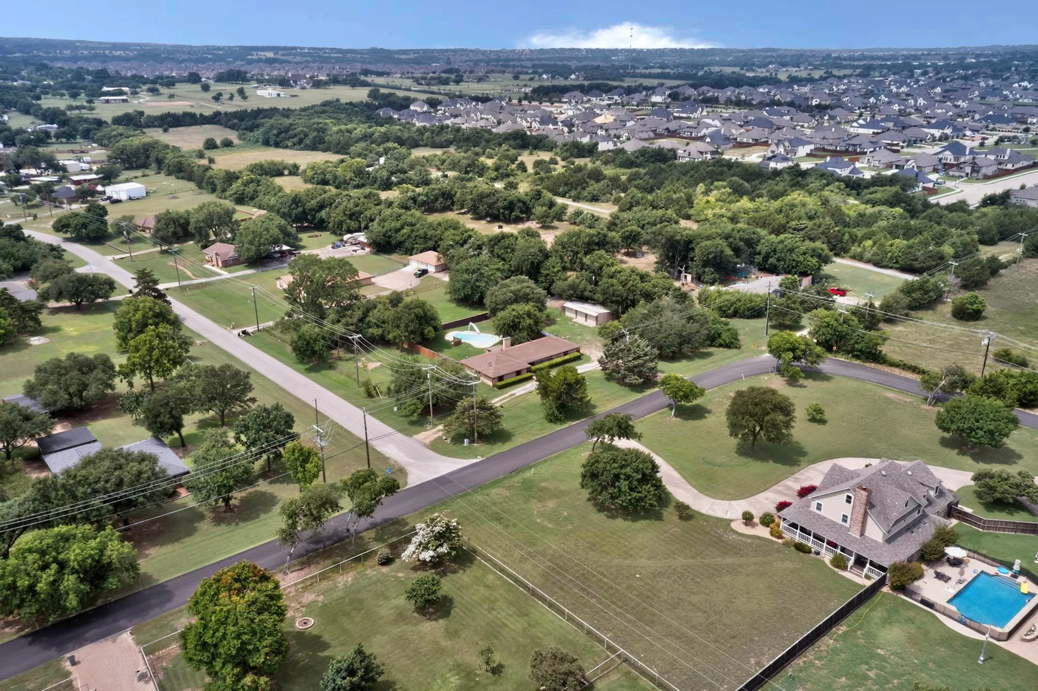 Expansive aerial view showcasing residential properties amidst abundant mature trees