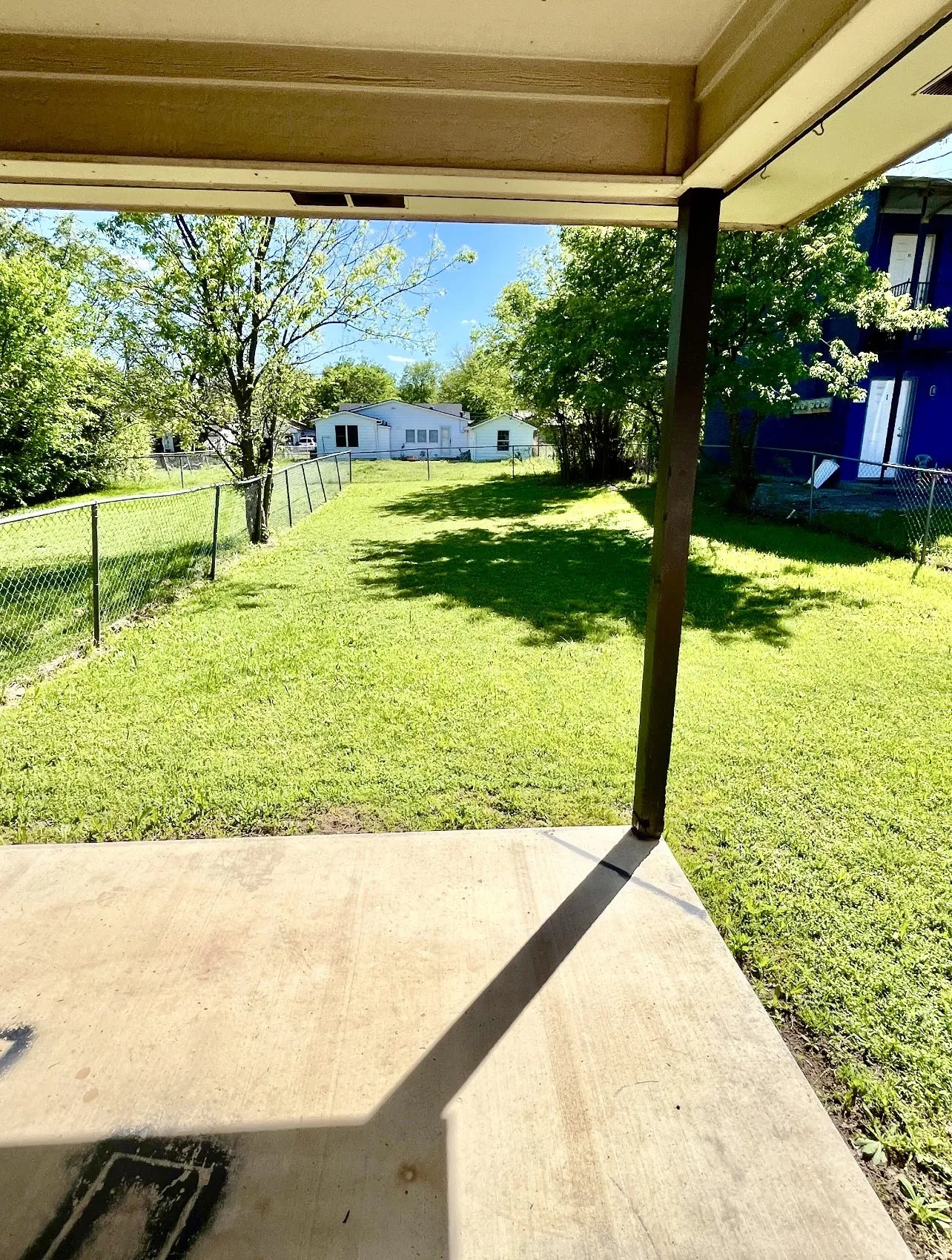 Fenced backyard with a patio area
