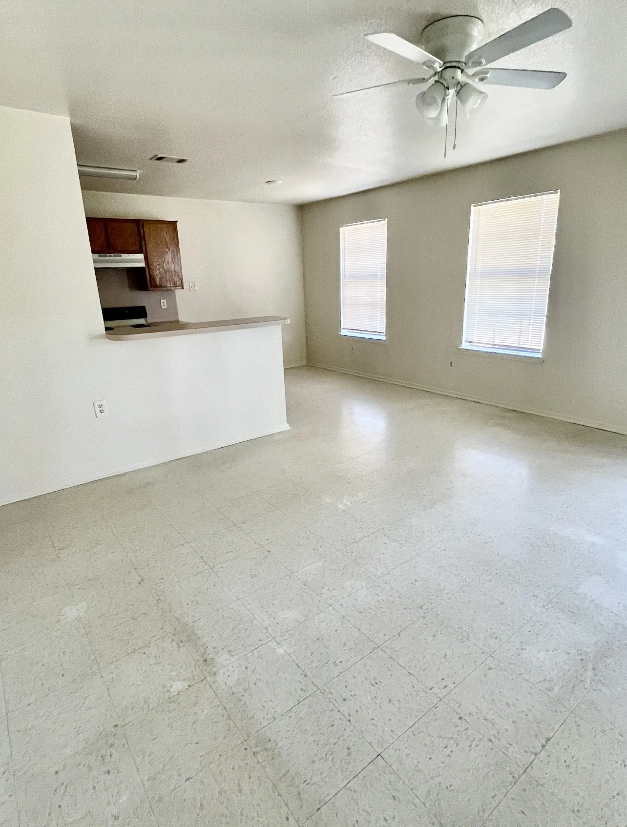 Unfurnished living room with light flooring and a textured ceiling