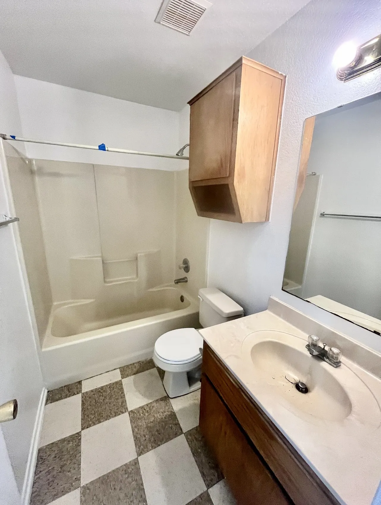 Bathroom with bathing tub / shower combination, light flooring, and vanity