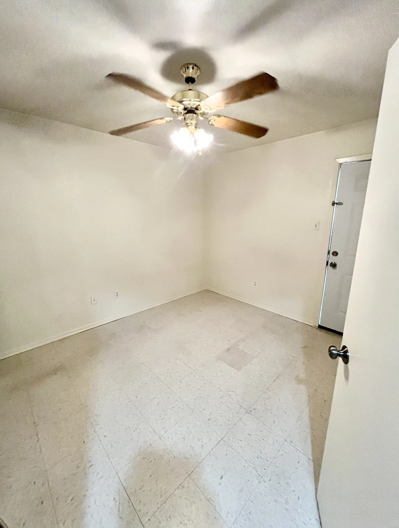 Unfurnished room with light floors and a textured ceiling