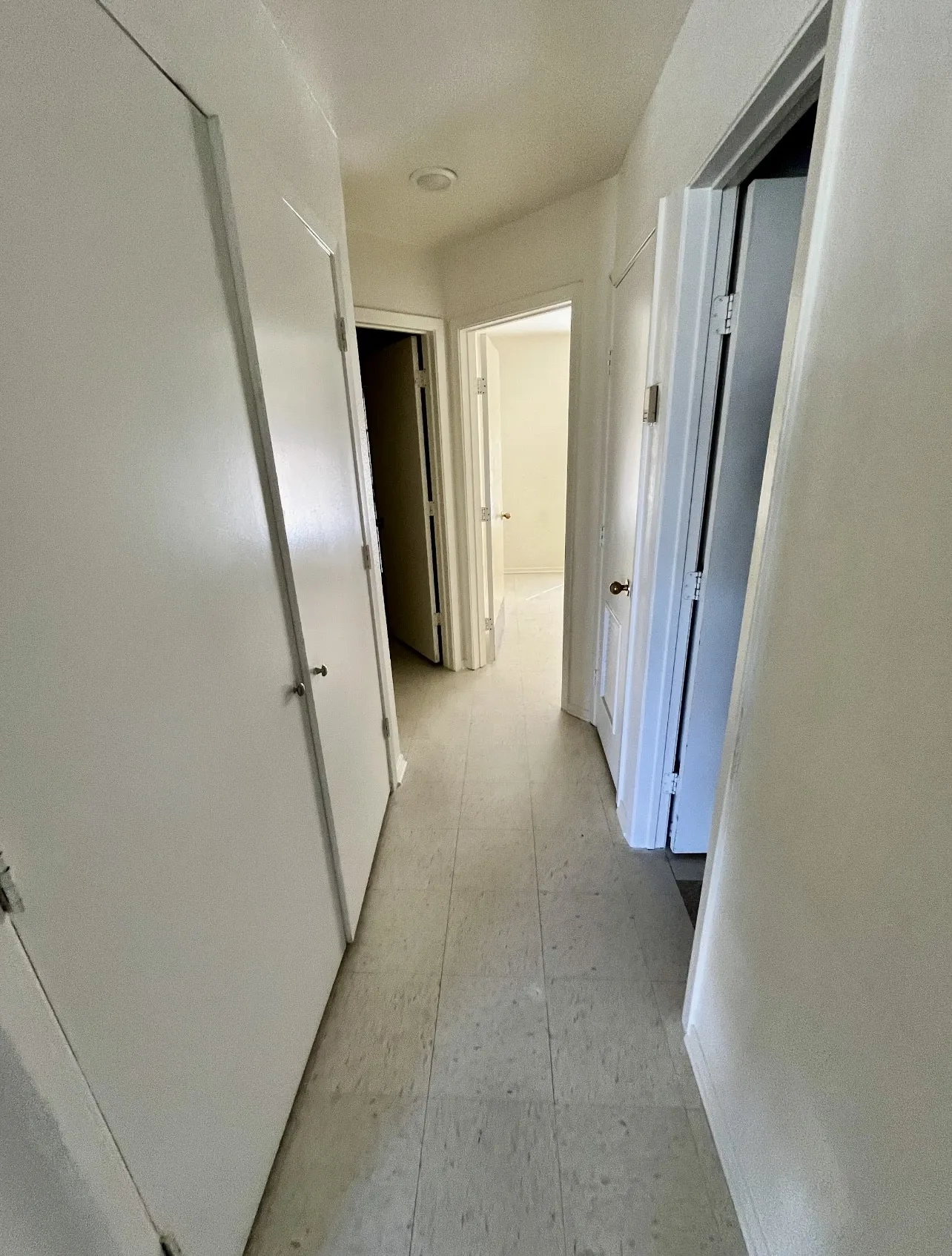 Corridor featuring light flooring