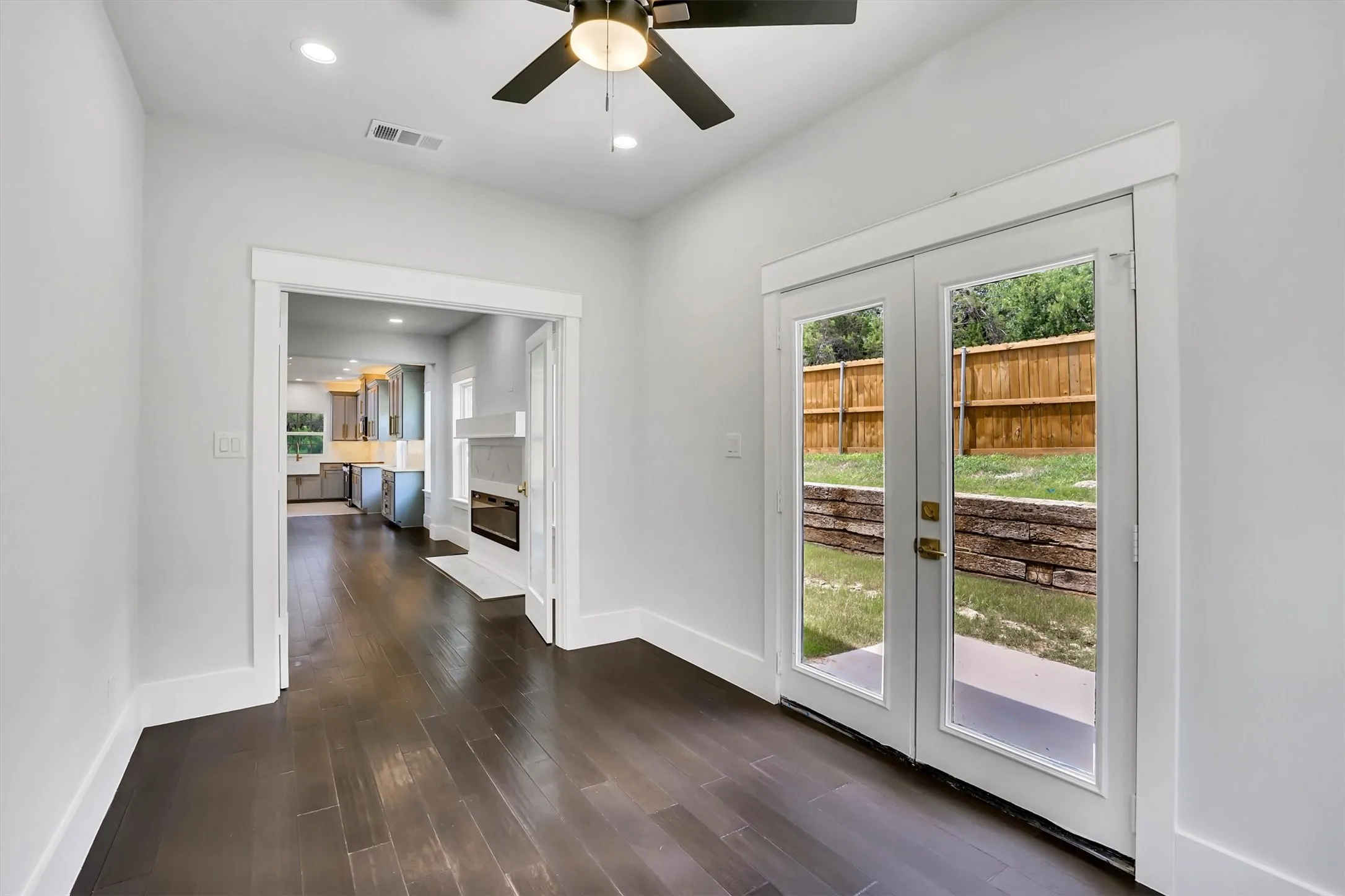 Room featuring dark wood-finish flooring and white baseboards