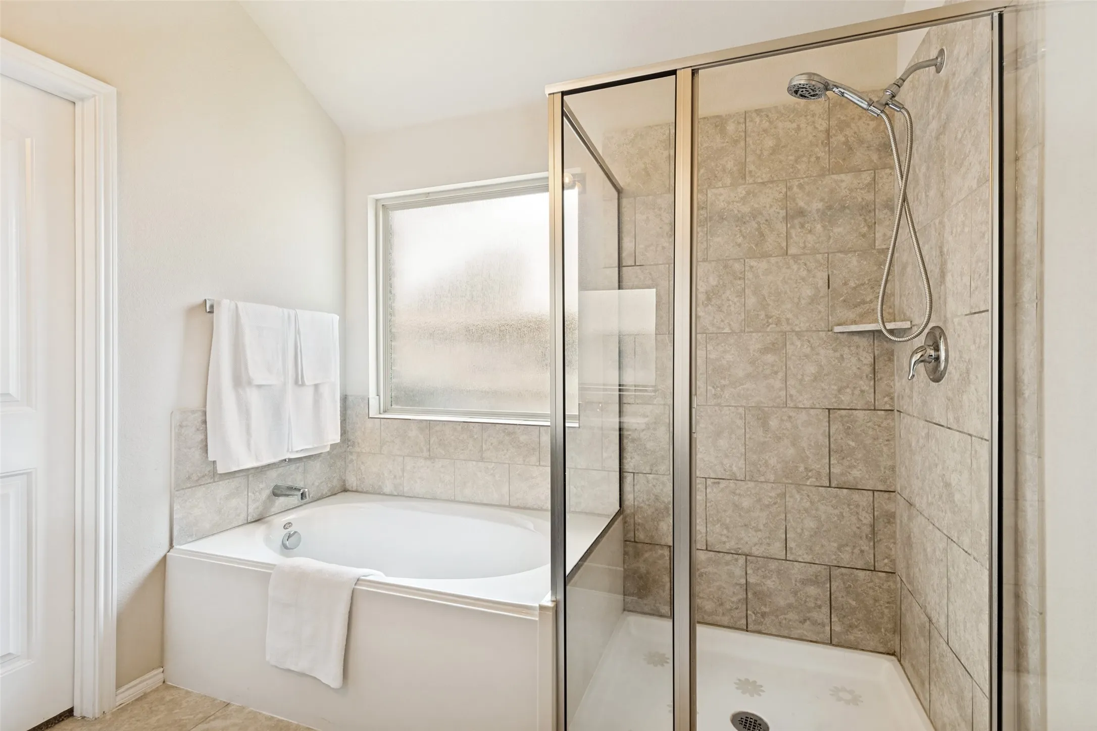 Primary bathroom features dual sinks, a separate tube and shower and a walk in closet!