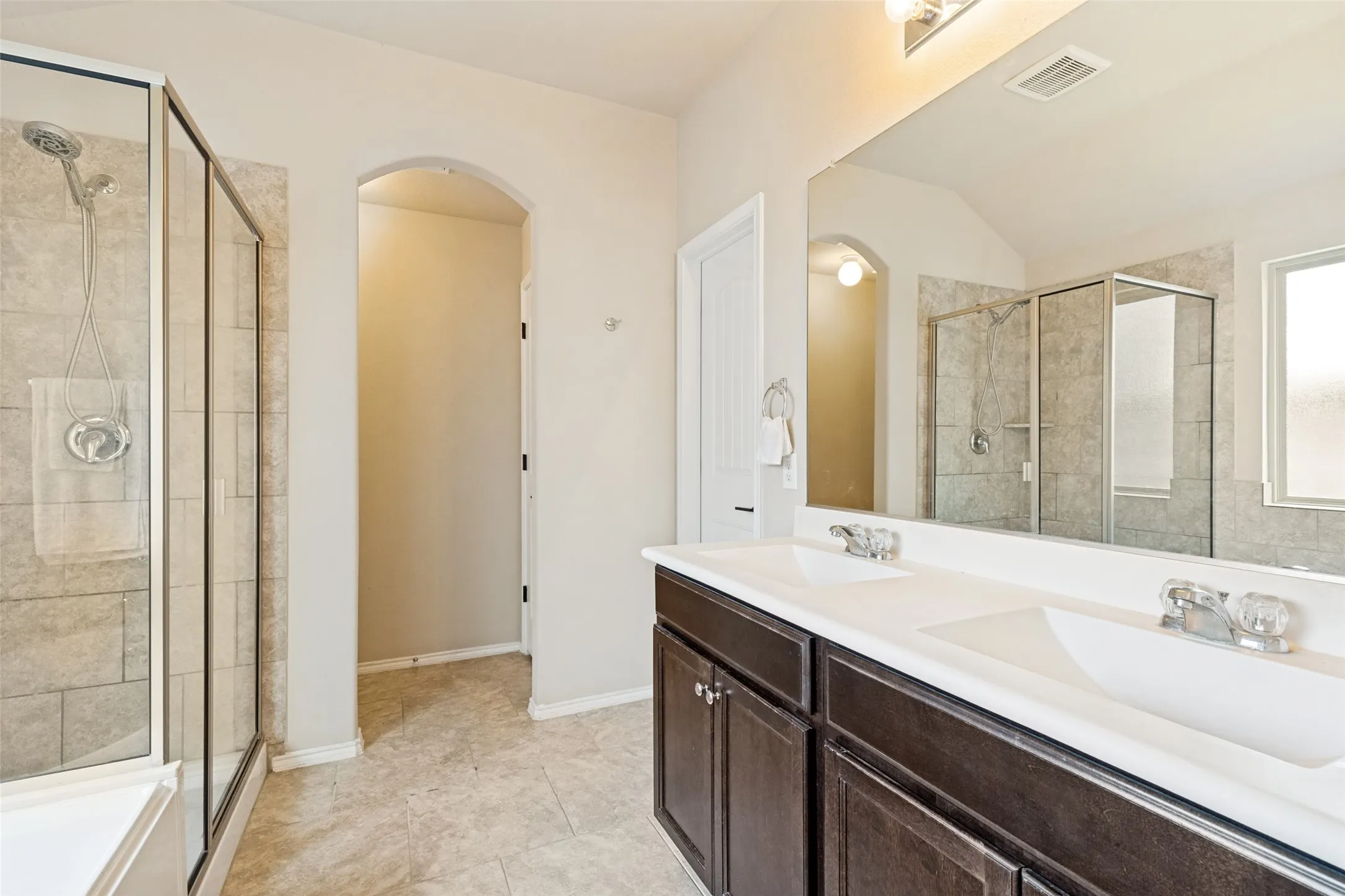 Primary bathroom features dual sinks, a separate tube and shower and a walk in closet!