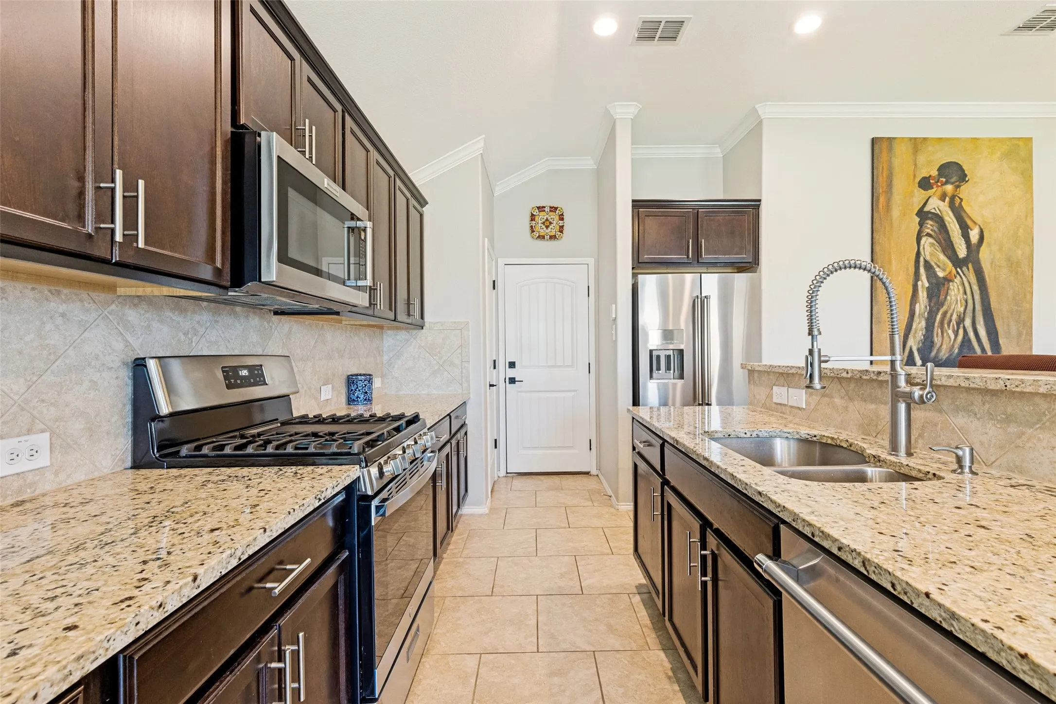 High end wood cabinetry, stone countertops, a sweep-in sink, and high end appliances make cooking here a chef's dream!