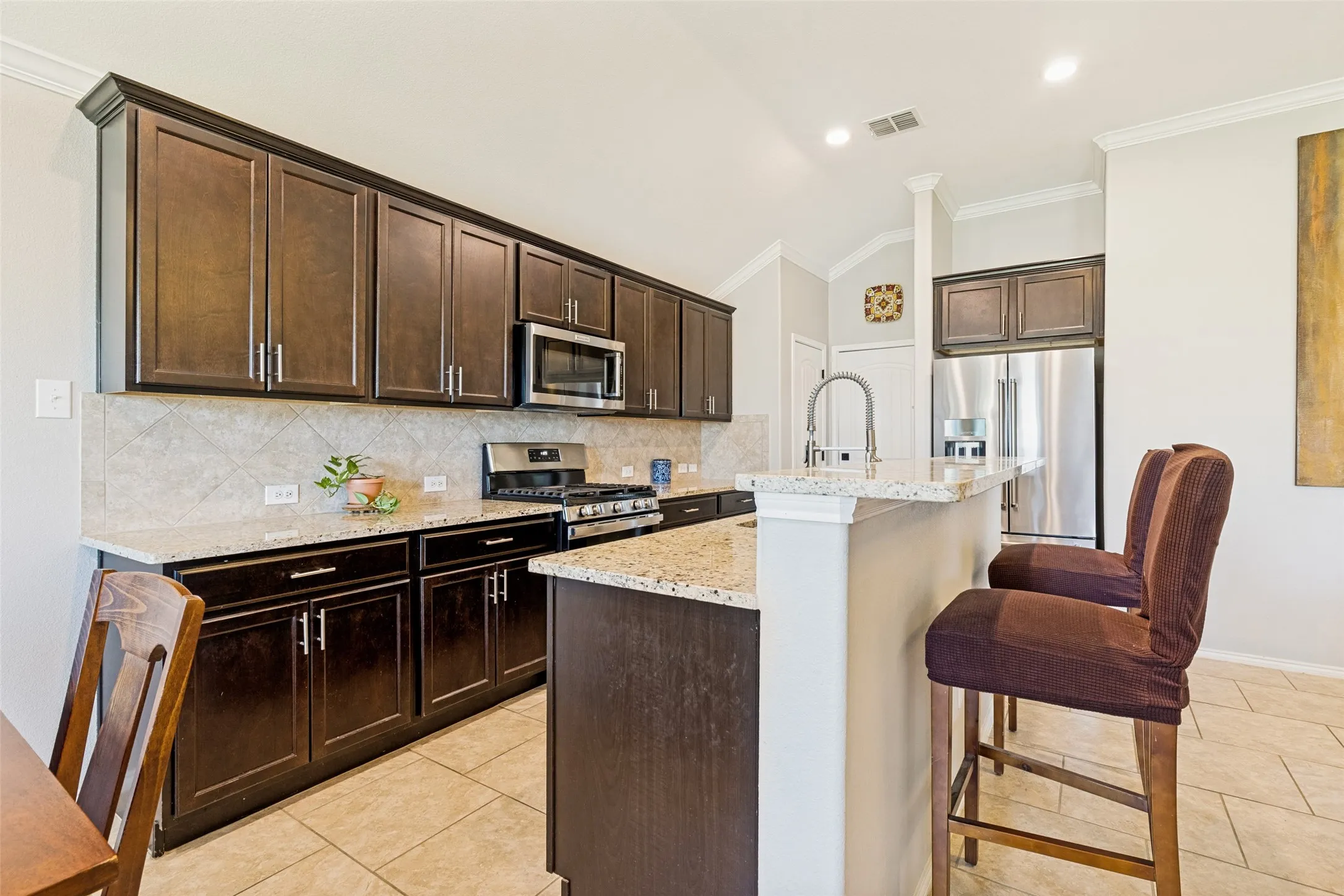 Stone countertops and an undermount sink, overlooking the living space