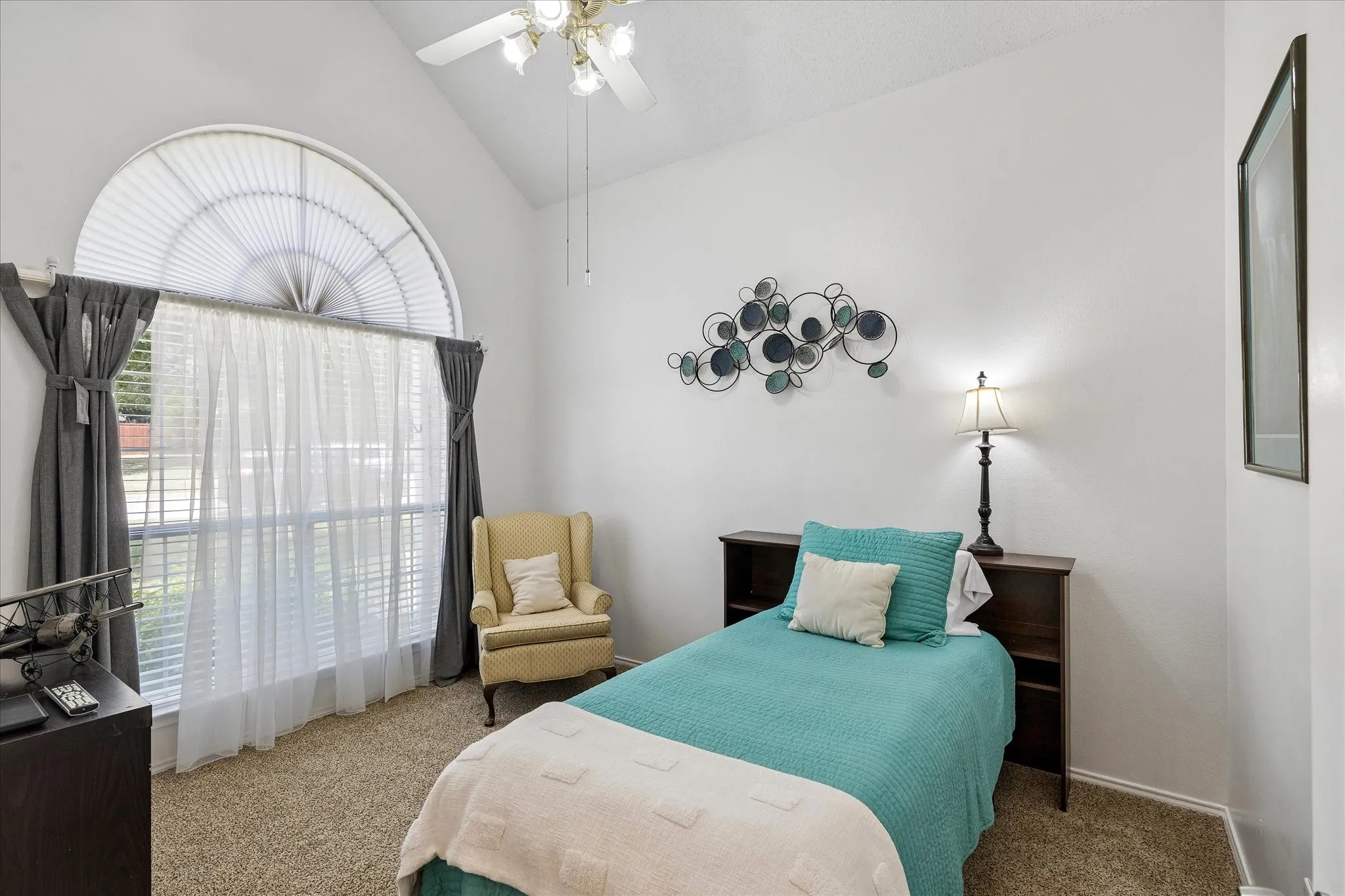 Bedroom 2 has a walk in closet and a vaulted ceiling .
