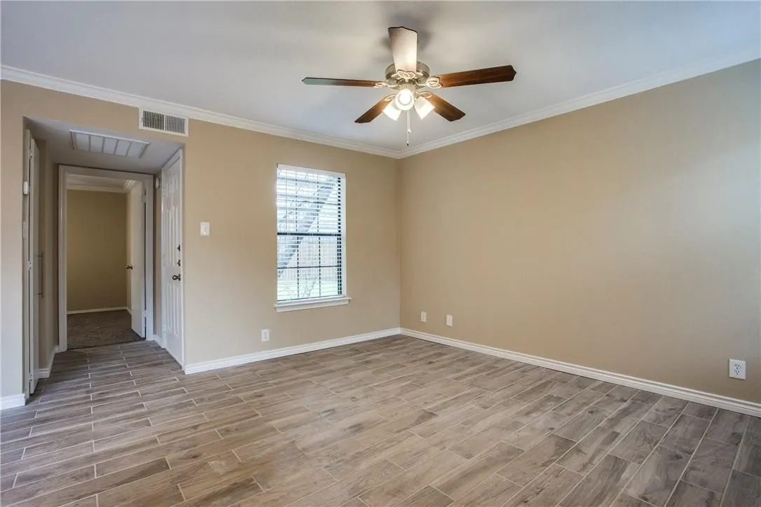 Spare room featuring ceiling fan and ornamental molding