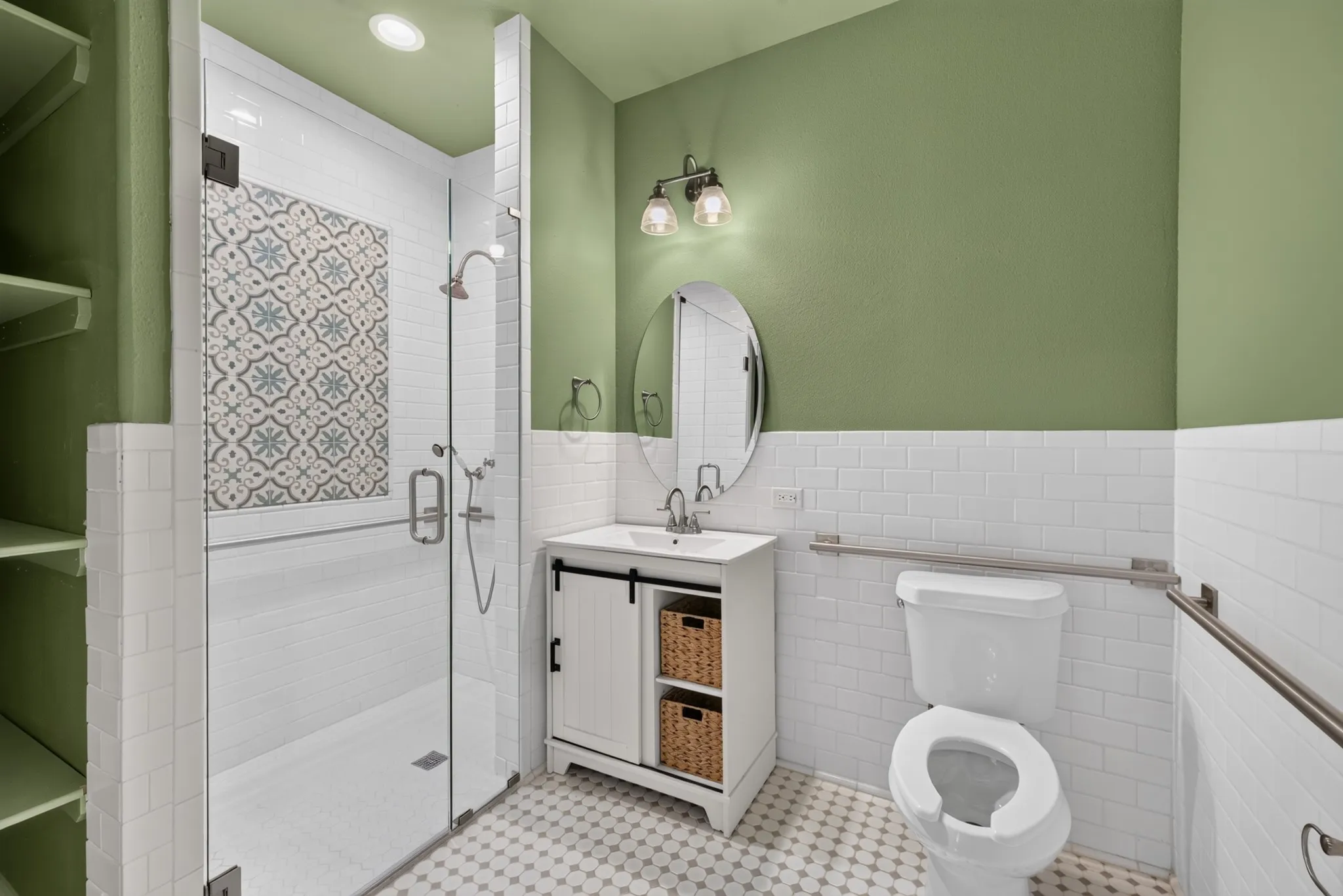Walk-in shower with patterned tile accent, glass enclosure, and built-in shelving