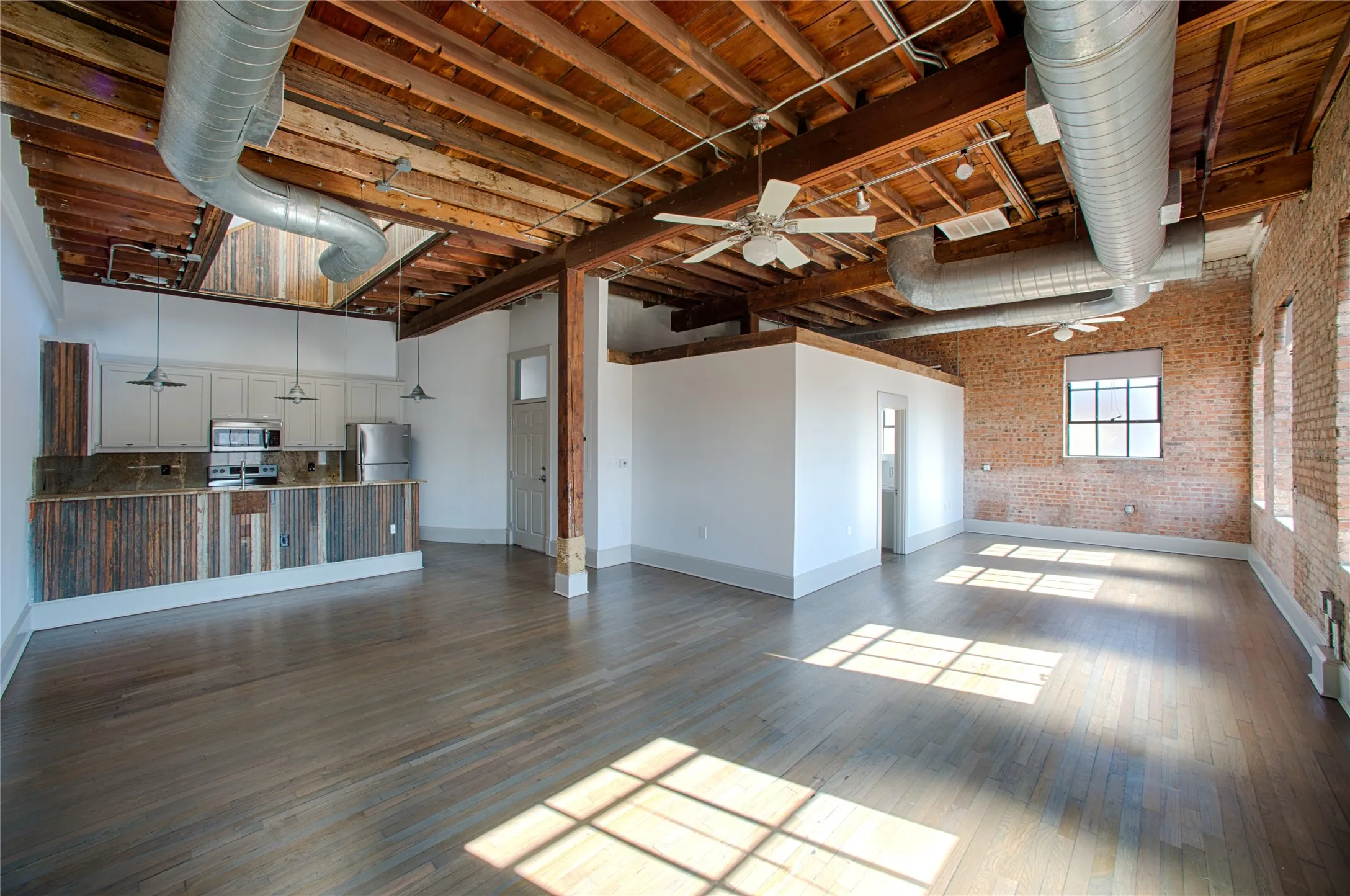 View of the studio. Plenty of room for a dining area, living area and bedroom space. Windows along the back wall allow lots of sunshine to stream into the space
