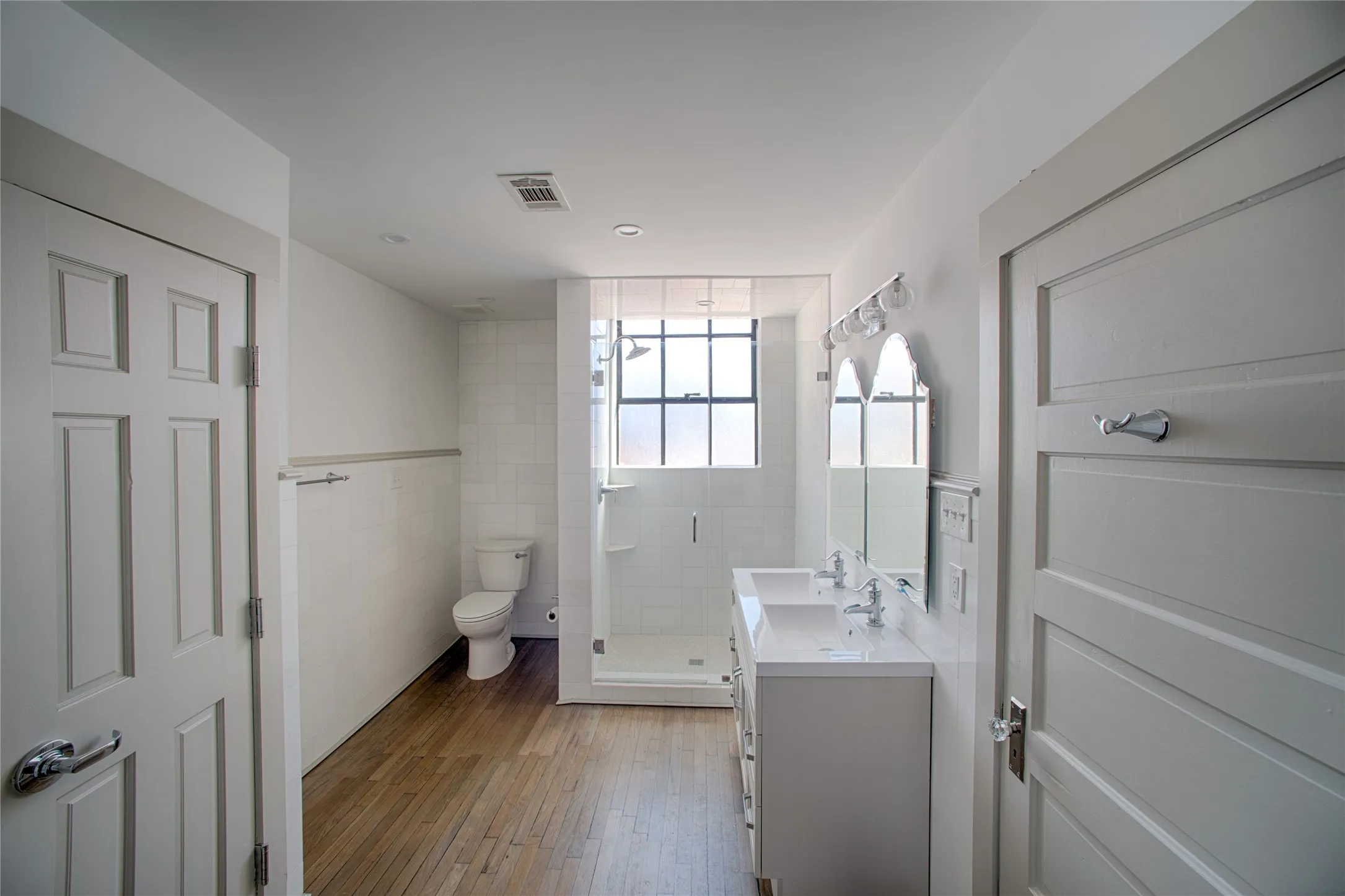 Beautiful bathroom with double-sinks. Laundry in closet