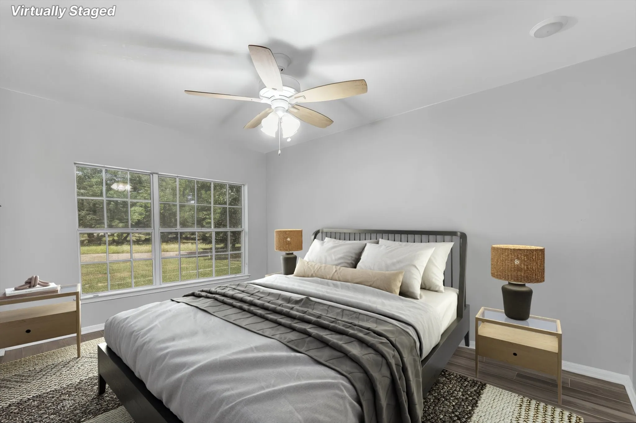 Bright room featuring a window, wood-finish flooring, a ceiling fan with light fixture. Virtually staged