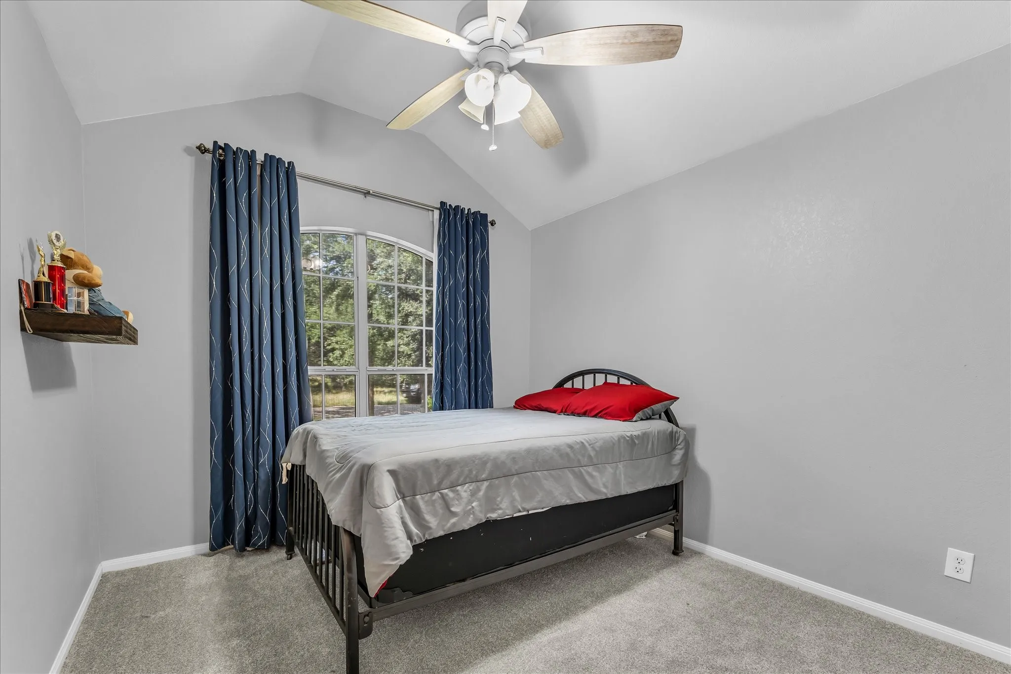 Vaulted ceiling bedroom featuring a ceiling fan, carpet, and light grey walls