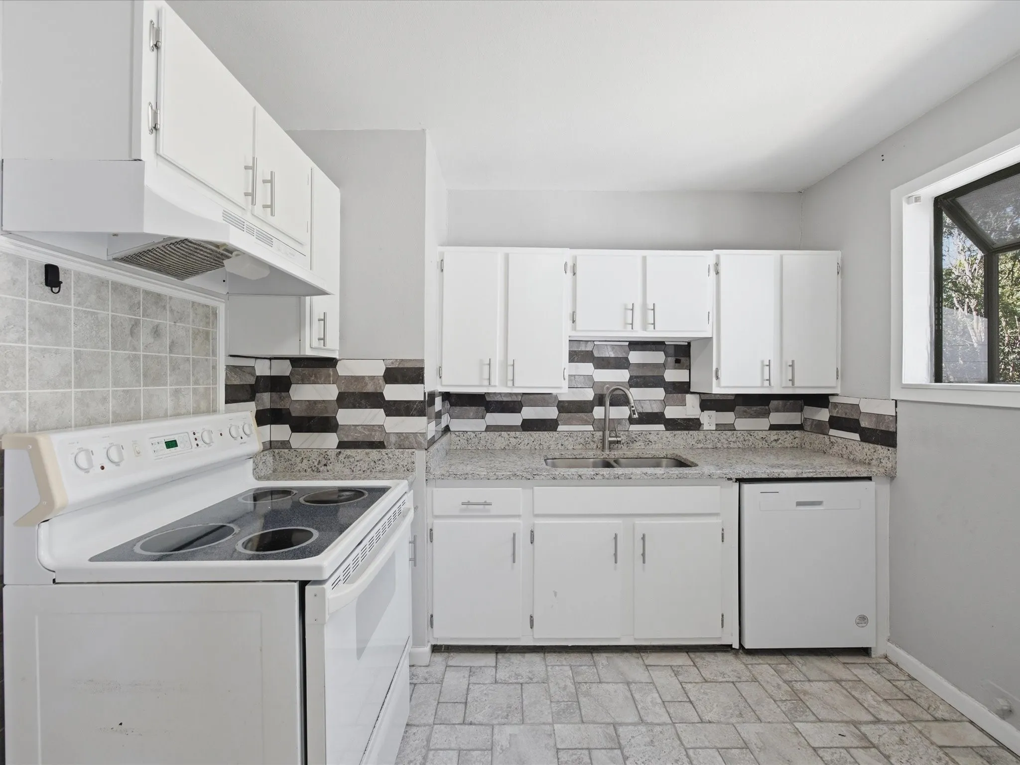 Kitchen featuring white cabinetry, a dual-tone tile backsplash, granite-patterned countertops, and a full suite of appliances including a range, vent hood, and dishwasher