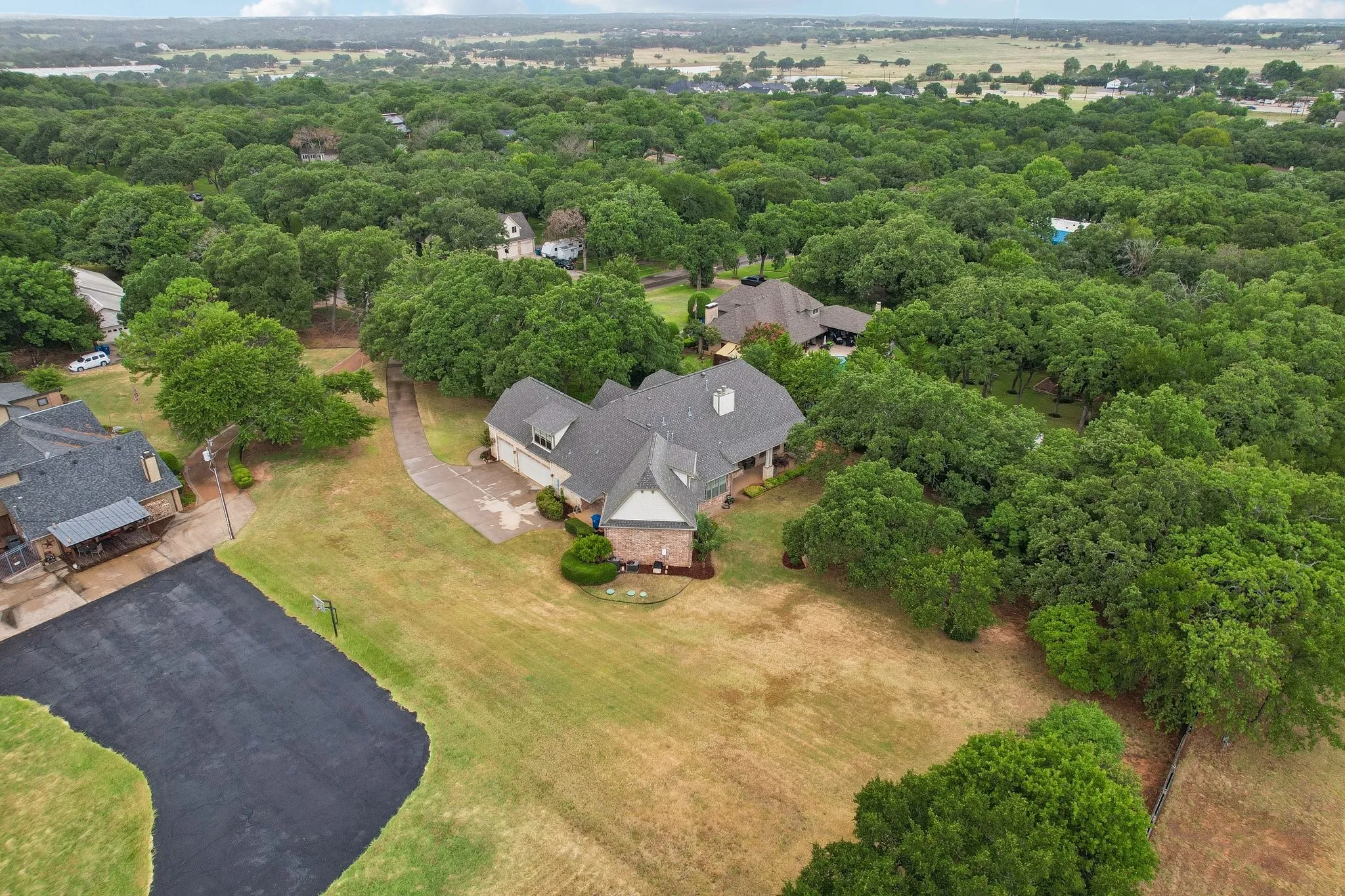 Expansive property featuring mature trees and a substantial residence
