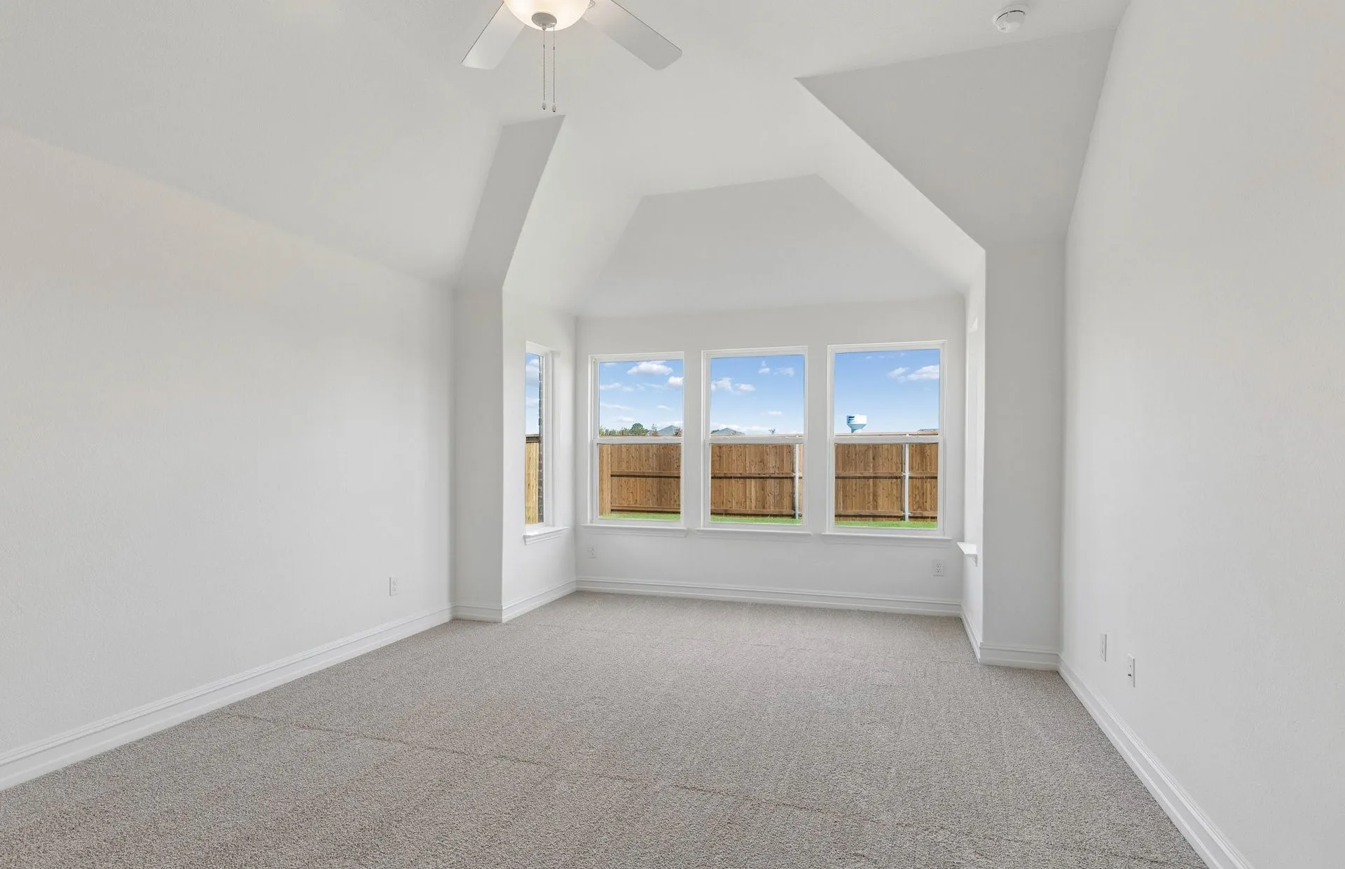 Primary bedroom with vaulted ceiling