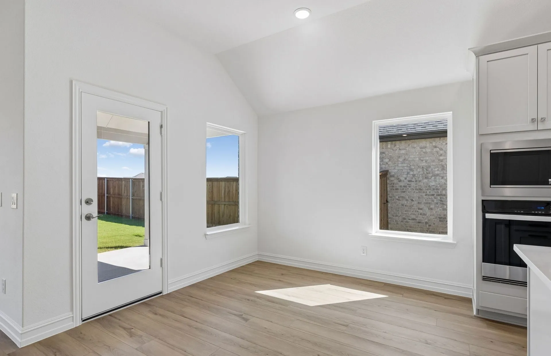 Dining nook off kitchen with large windows