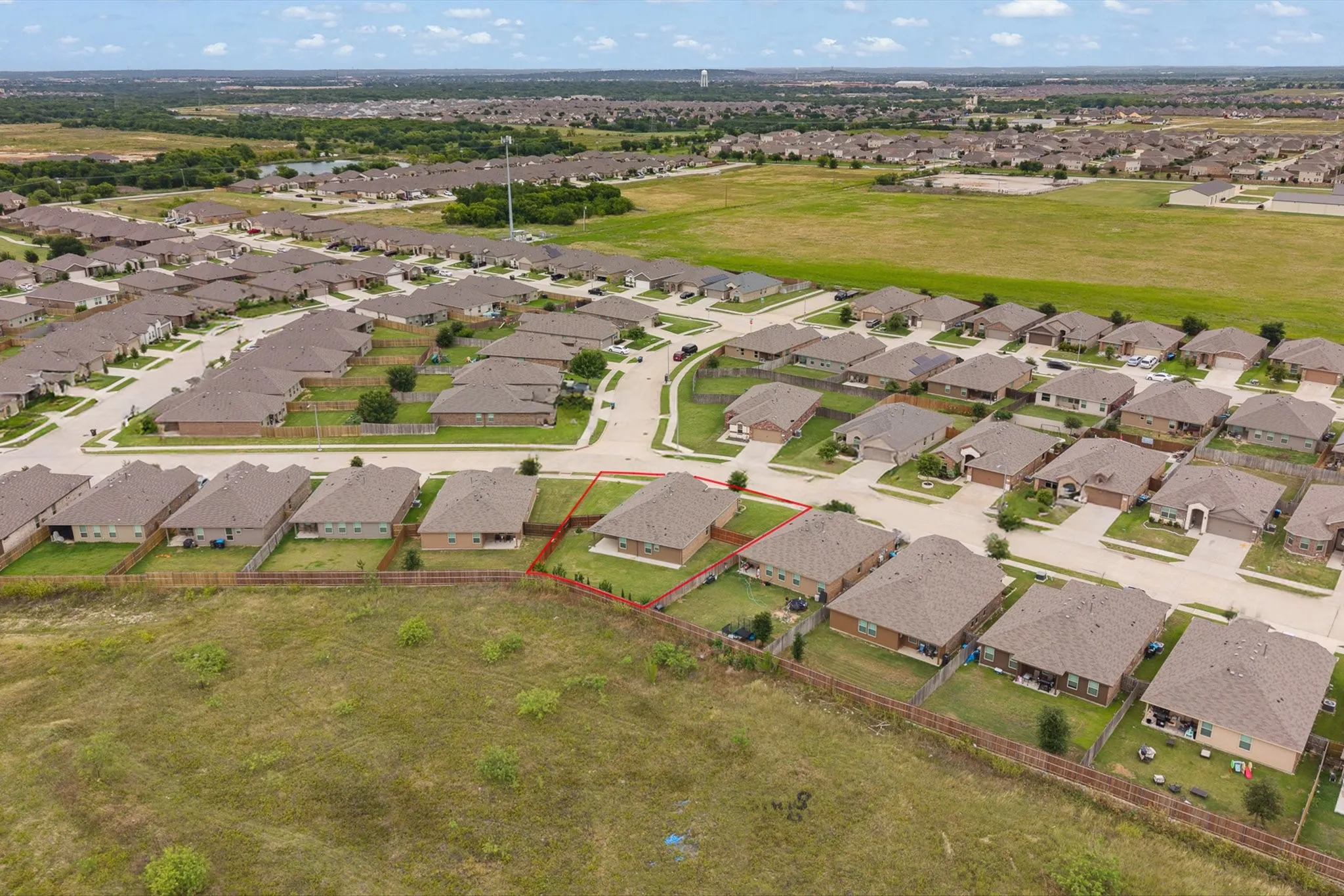 Aerial perspective highlighting a residential community with uniform housing styles
