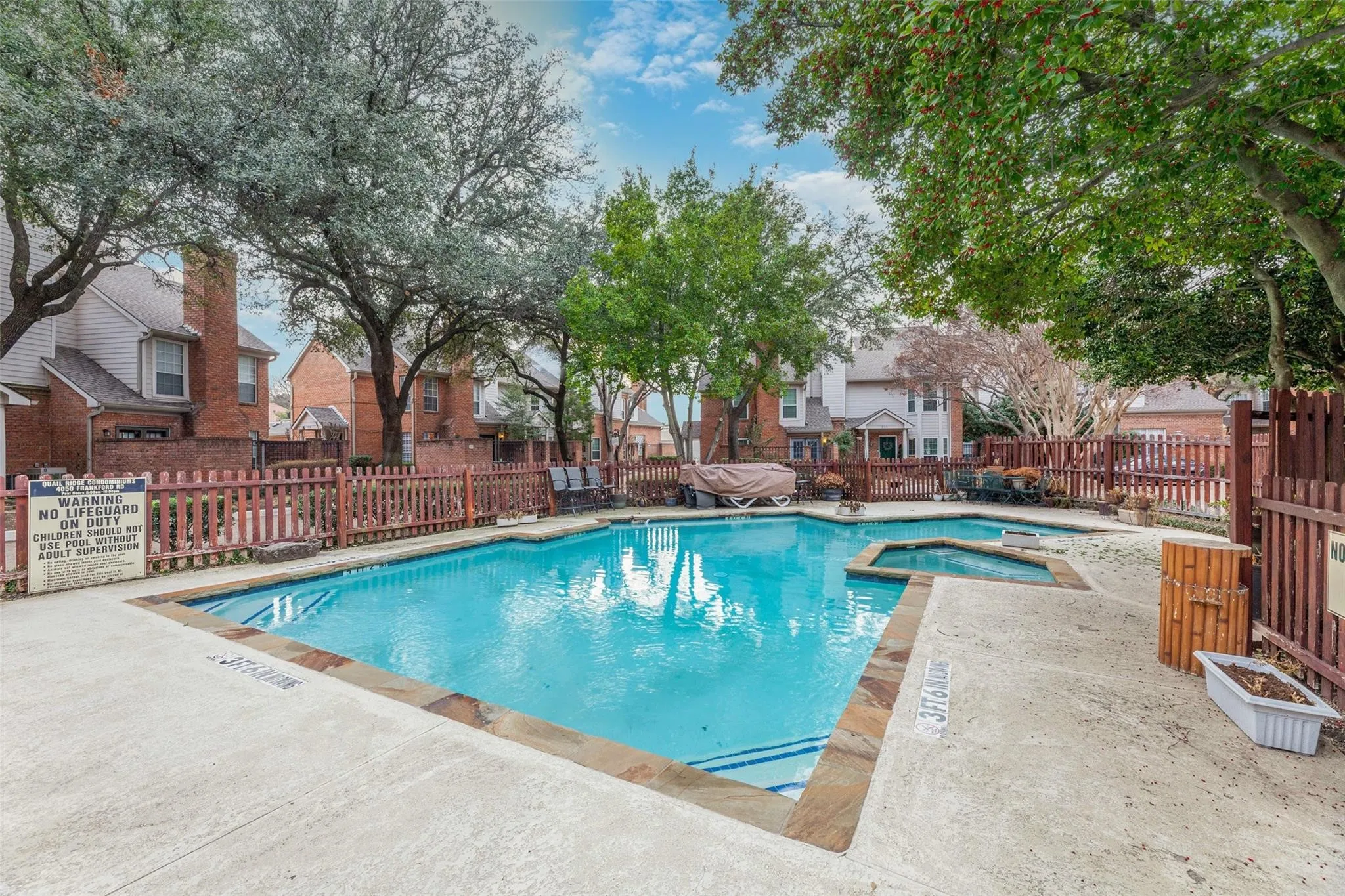 Community pool with integrated spa and stone coping