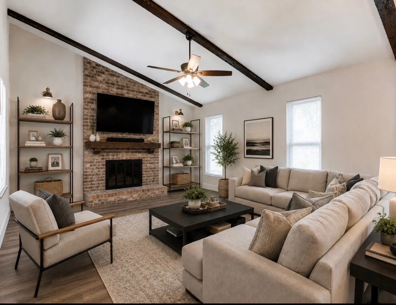 Virtually Staged. Vaulted ceiling with exposed wood beams, brick fireplace with wood mantel, ceiling fan, and wood-finish flooring