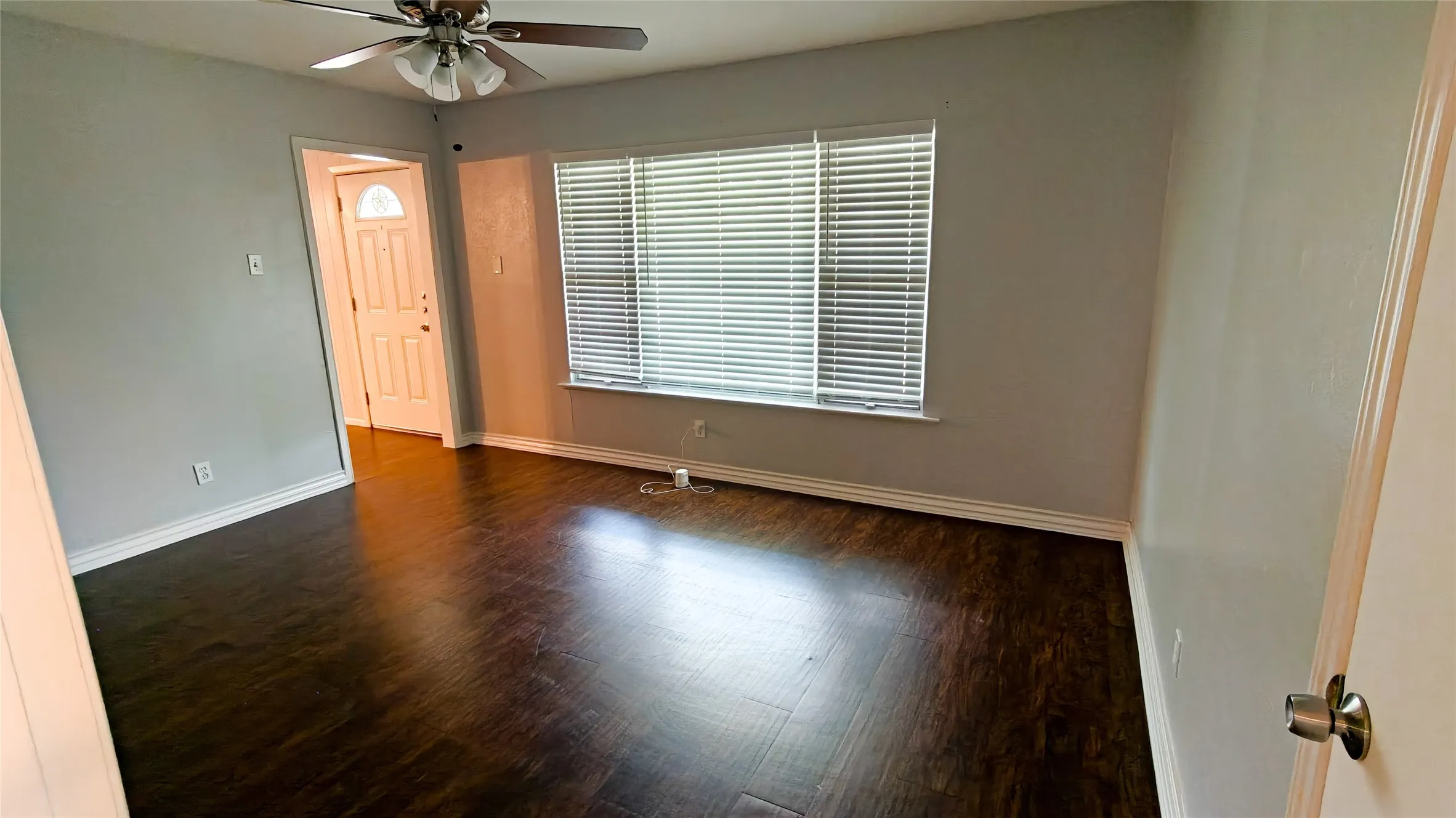 Spacious interior room featuring dark wood-finish flooring