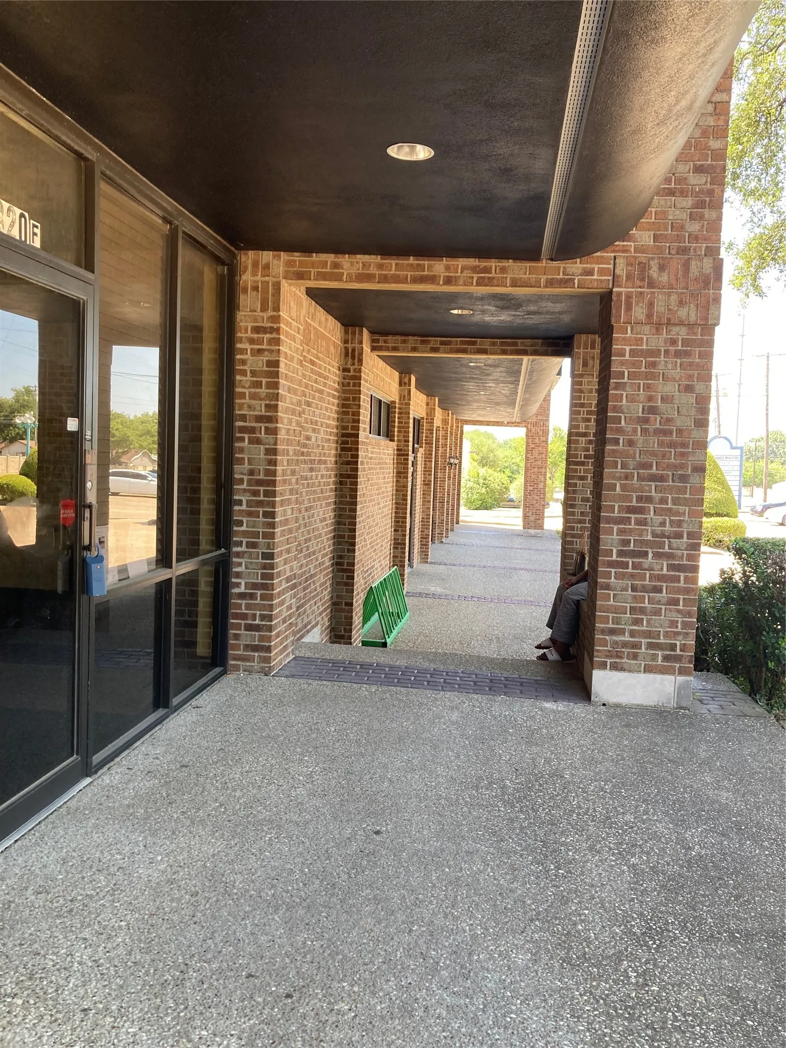 Recessed building entrance featuring full-light glass doors
