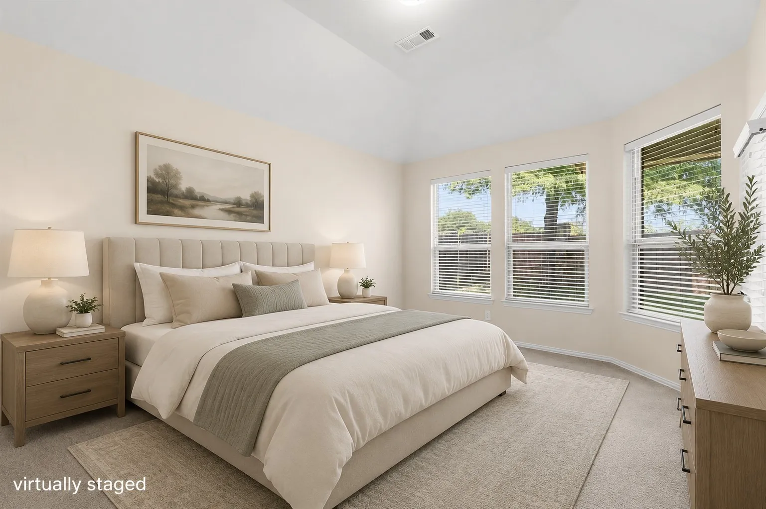 Vaulted ceiling, multiple windows with blinds, light-toned walls, and carpet flooring