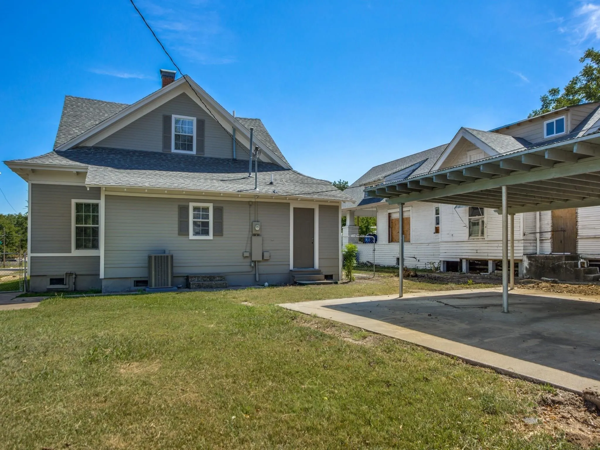 Grey siding exterior with white trim and dark window shutters