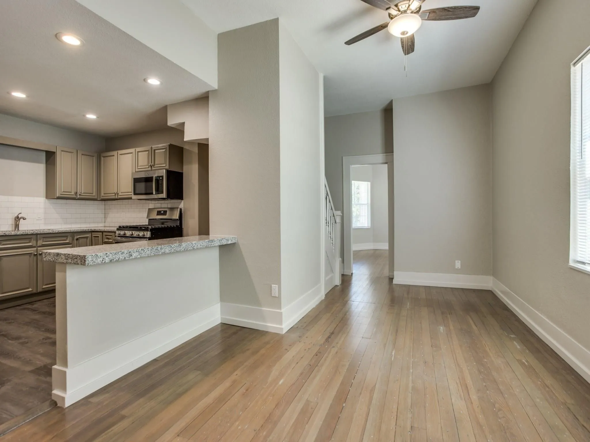Open-concept living space with wood-finish flooring