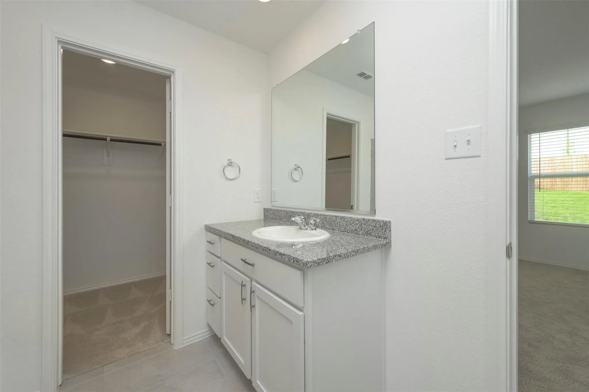 Bathroom with tile flooring and vanity